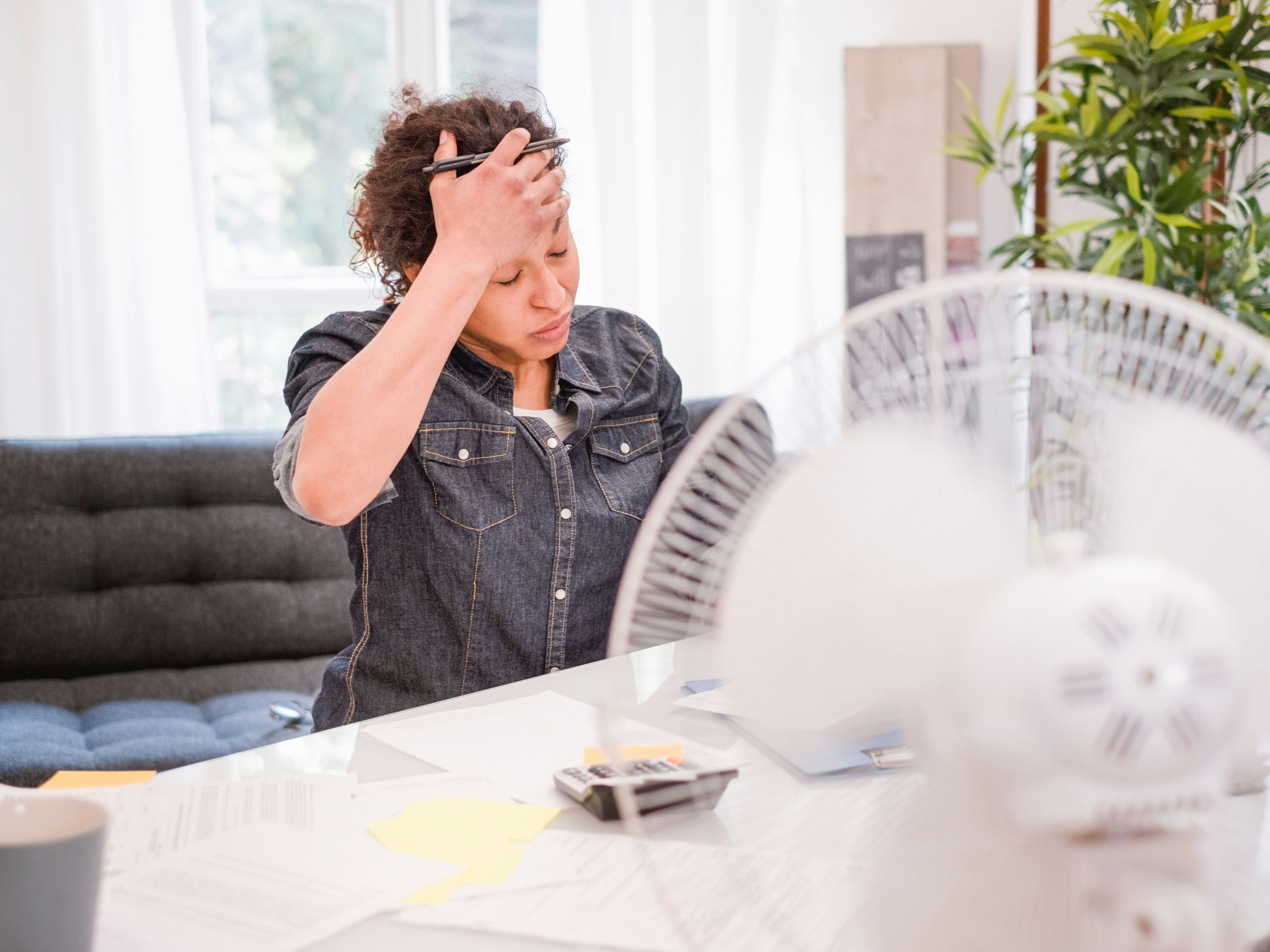 Woman sweating and suffering for summer heatwave