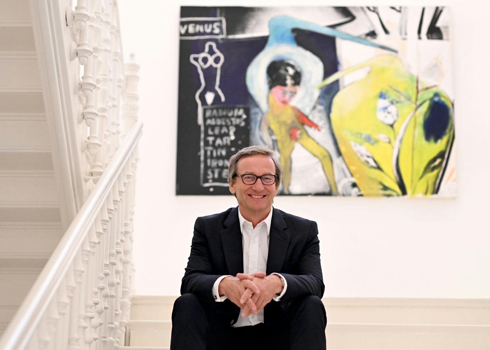 Galerist Thaddaeus Ropac vor dem Kunstwerk Basquiat Clemente Warhol Ex-Ringeye, 1984, in der Galerie am Dienstag, 25. Juli 2023, in Salzburg.