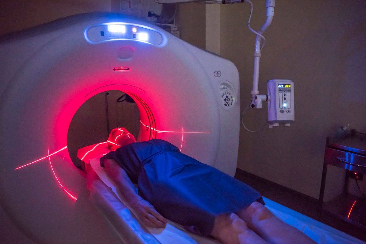 Person undergoing a CAT scan in hospital. PET scan equipment. Medical scan of patient.