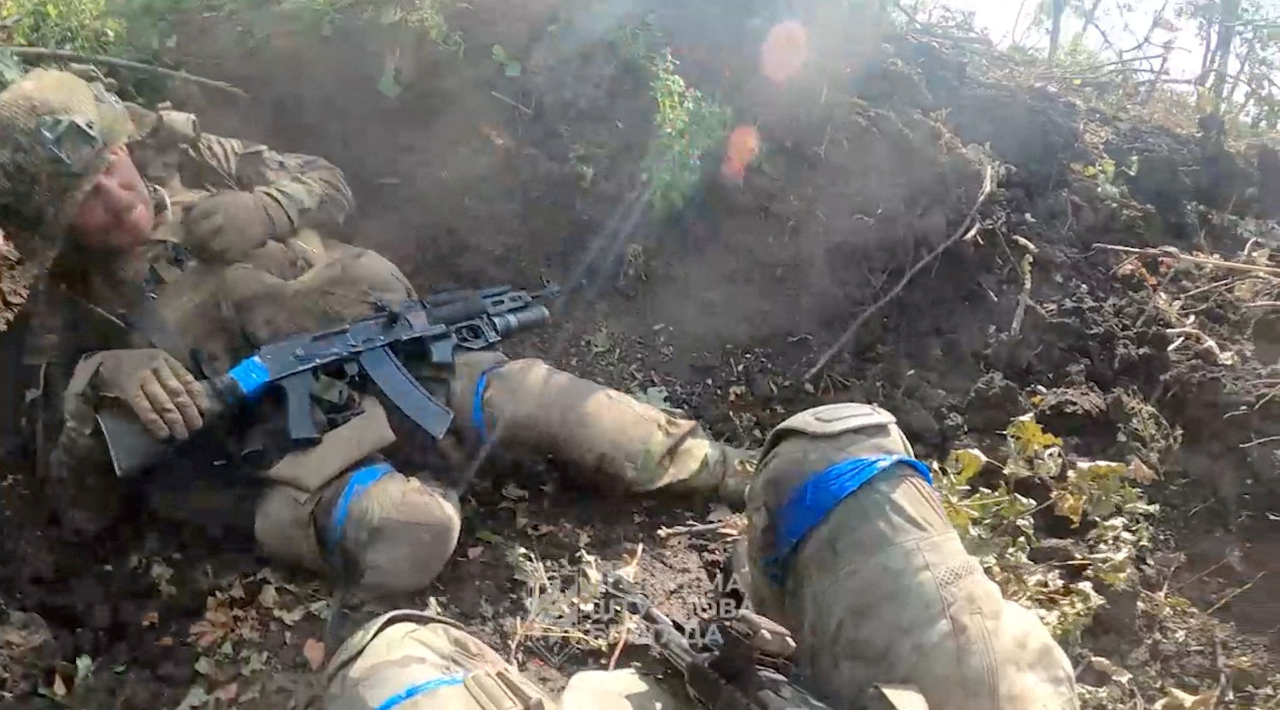 Ukrainian soldiers take cover in a wooded area amid gunfire, near Bakhmut, Ukraine in this screen grab obtained from a social media video released on July 28, 2023. 3rd Assault Brigade/Ukrainian Armed Forces Press Service/via REUTERS  THIS IMAGE HAS BEEN SUPPLIED BY A THIRD PARTY. MANDATORY CREDIT. 
