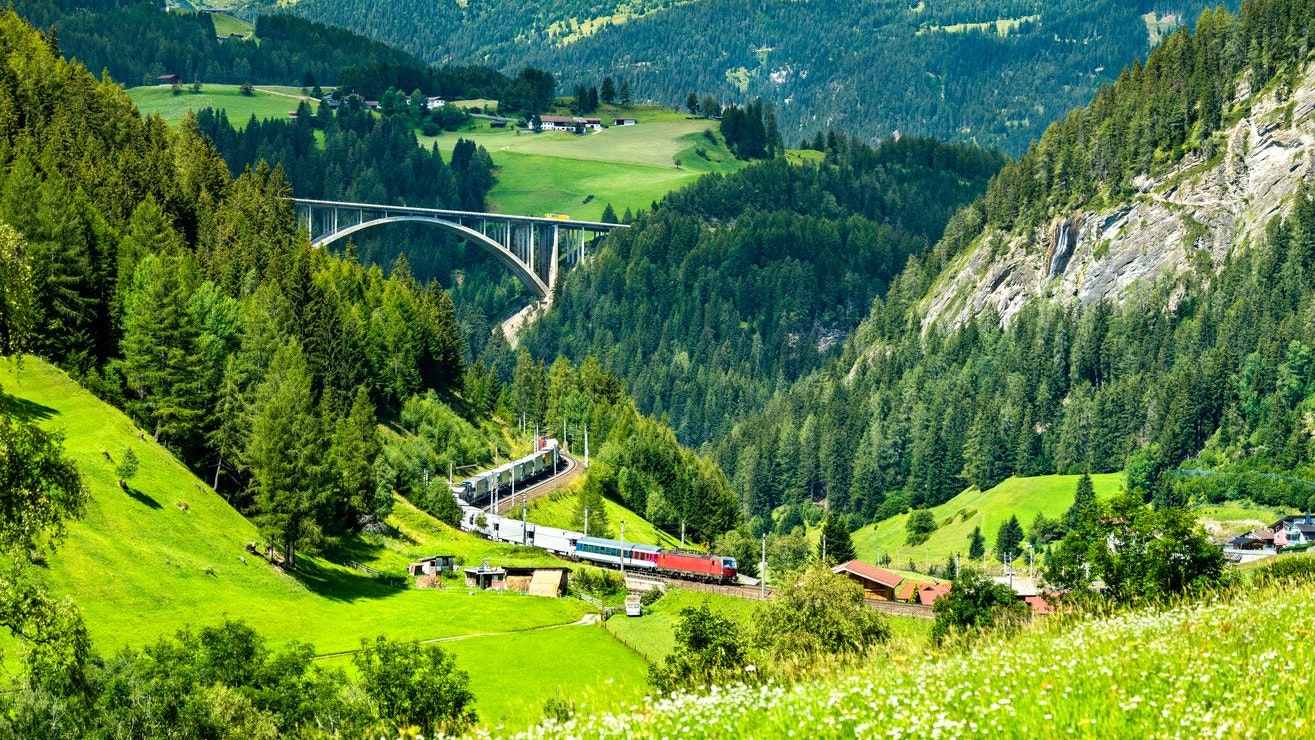 Train with trailers crossing the Alps at the Brenner Pass in Austria
