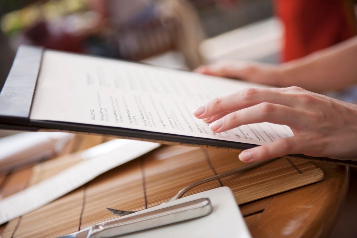 Close-up of woman's hands holding menu