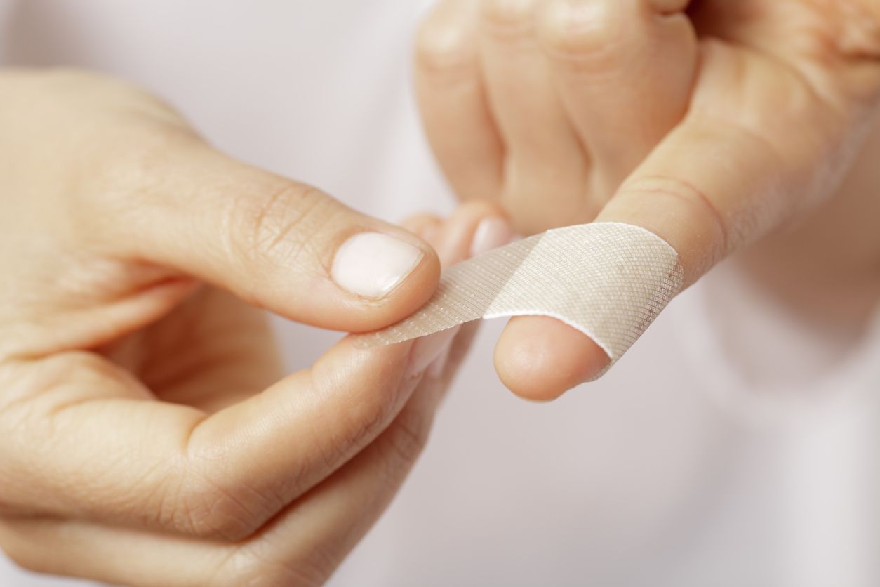 Forefinger of a woman hand with a band aid