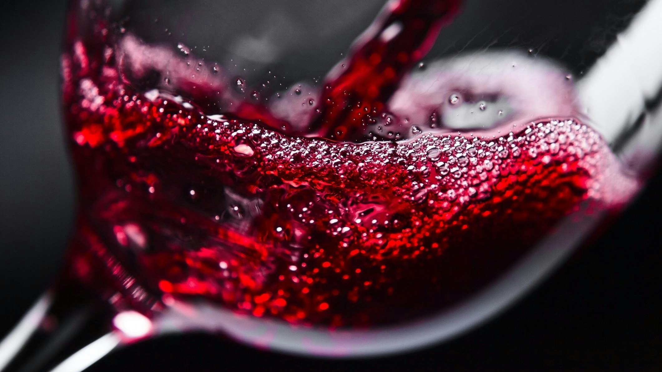 Red wine in wineglass on  black background