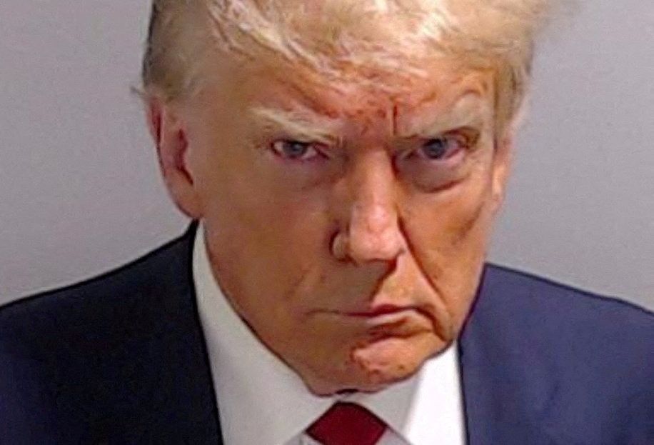 FILE PHOTO: Former U.S. President Donald Trump is shown in a police booking mugshot released by the Fulton County Sheriff's Office, after a Grand Jury brought back indictments against him and 18 of his allies in their attempt to overturn the state's 2020 election results in Atlanta, Georgia, U.S., August 24, 2023. Fulton County Sheriff's Office/Handout via REUTERS  THIS IMAGE HAS BEEN SUPPLIED BY A THIRD PARTY.  THIS PICTURE WAS PROCESSED BY REUTERS TO ENHANCE QUALITY. AN UNPROCESSED VERSION HAS BEEN PROVIDED SEPARATELY./File Photo