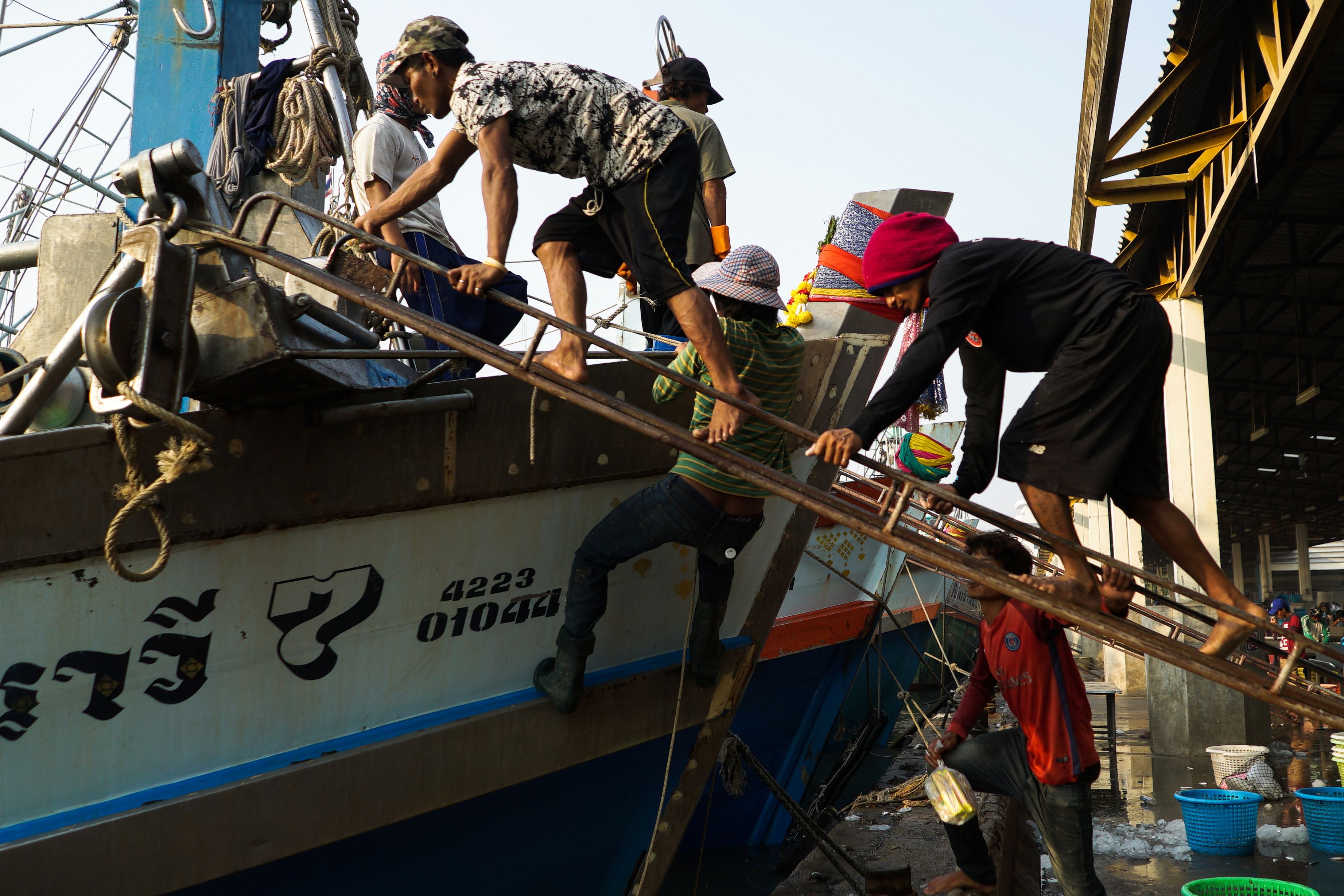Migrant workers prepare for another fishing trip at a port in Samut Sakhon province, Thailand, January 22, 2018. REUTERS/Athit Perawongmetha