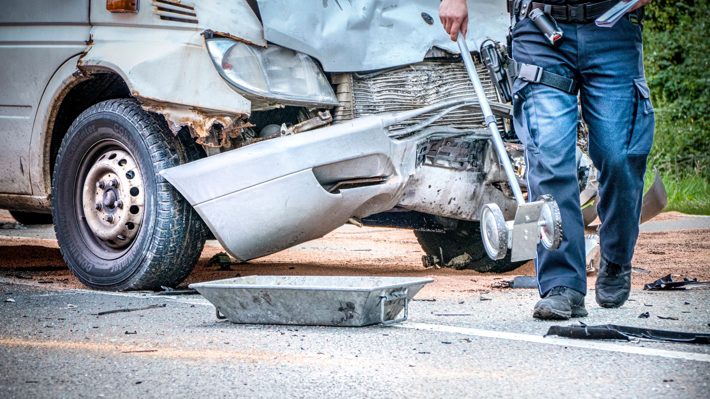 Hamburg, Germany - August 20. 2019: a policeman measures  and surveys the accident site after a serious accident in Hamburg - Germany