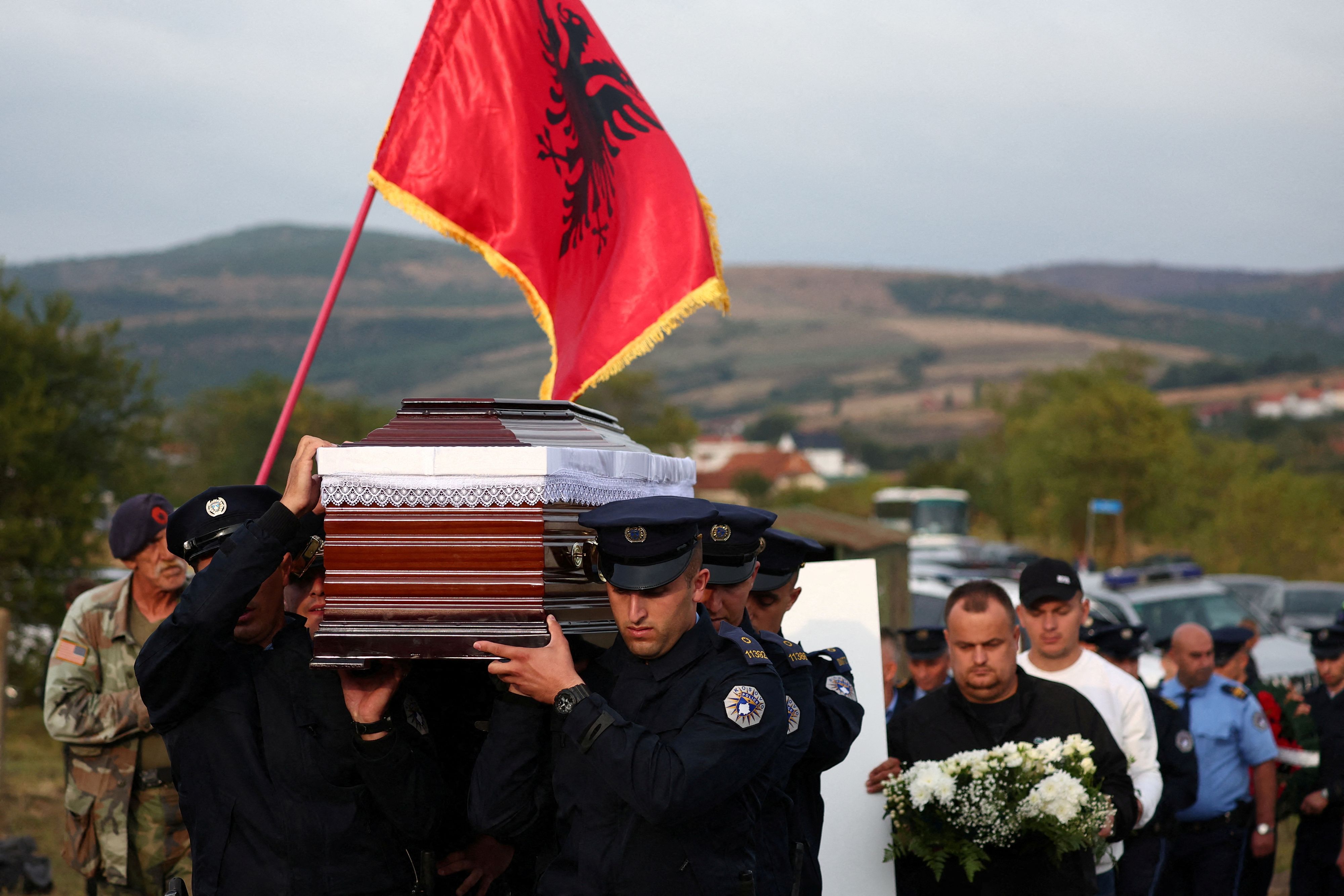 Police officers carry the coffin during the funeral of Afrim Bunjaku, a police officer killed in Kosovo shootout, near Vushtrri, Kosovo, September 25, 2023. REUTERS/Florion Goga