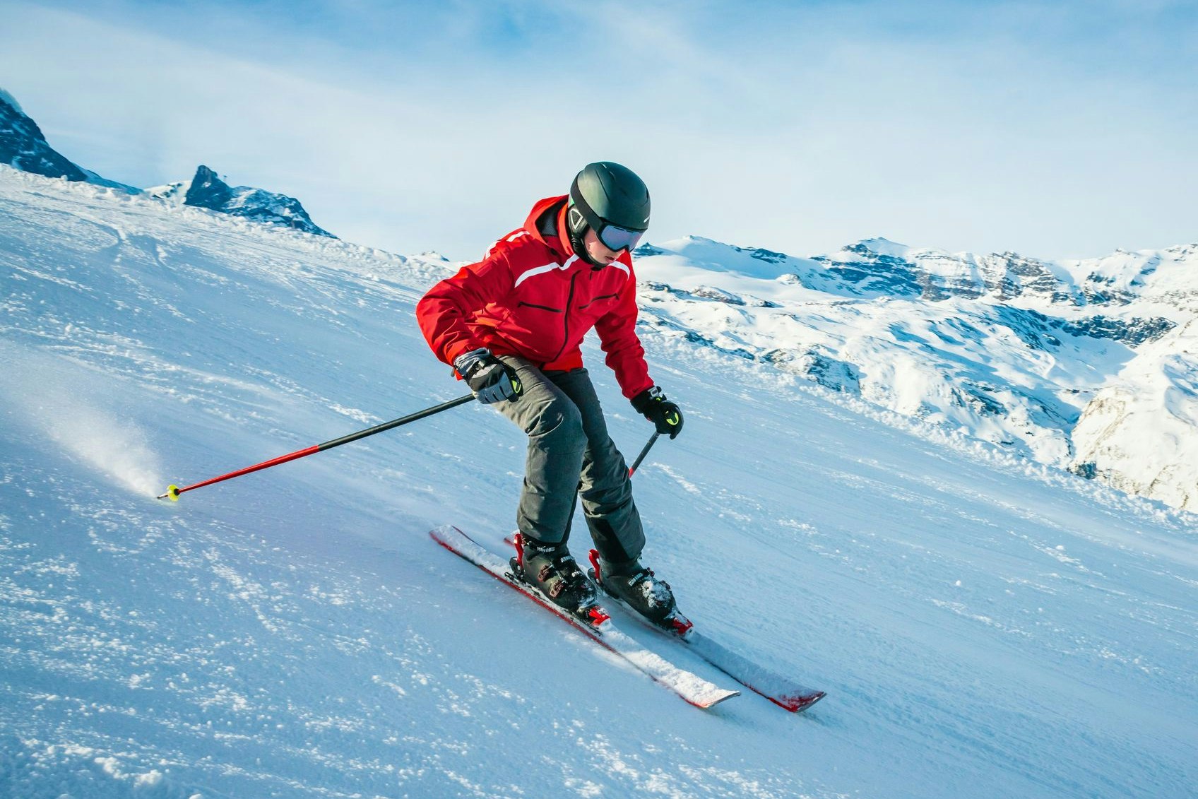 Young skier downhill skiing at Zermatt ski resort with Matterhorn mountain in background, Valais canton, Switzerland, in winter morning. Taken by Sony a7R II, 42 Mpix.