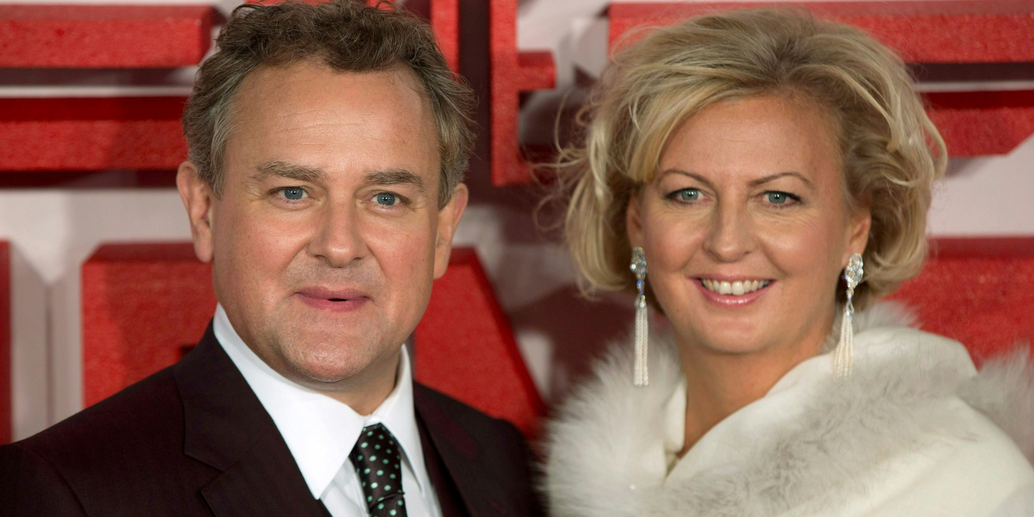 British actor Hugh Bonneville and his wife Lulu Williams arrive for the UK premiere of the film "The Monuments Men" in London February 11, 2014.  REUTERS/Neil Hall (BRITAIN - Tags: ENTERTAINMENT)
