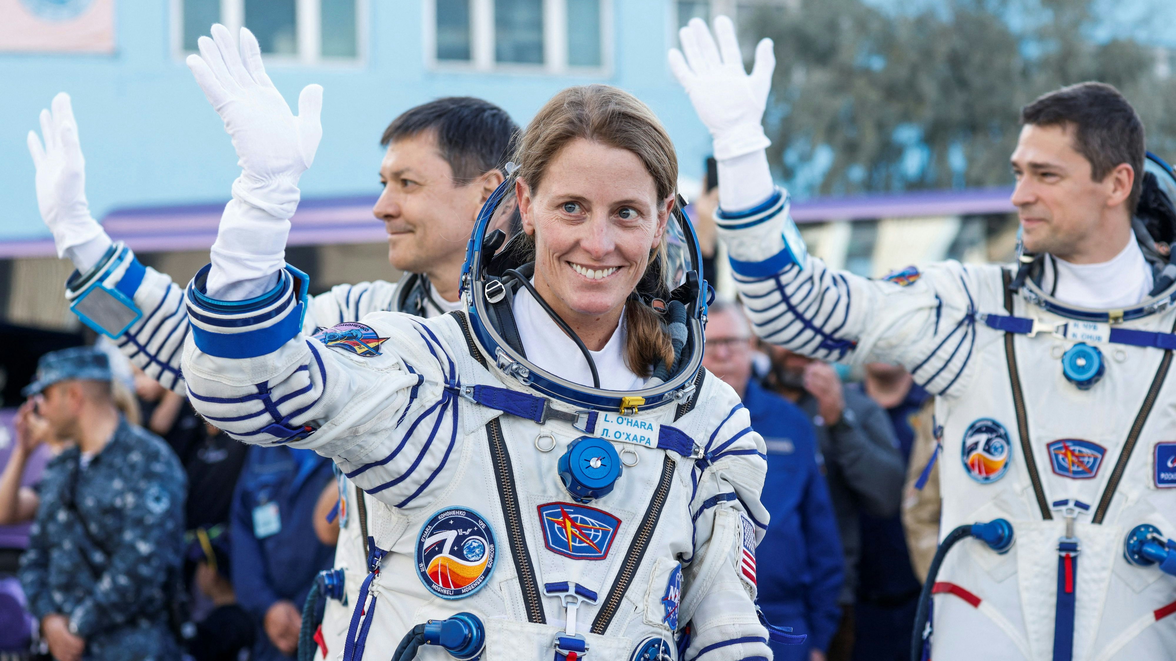 NASA astronaut Loral O'Hara along with Roscosmos cosmonauts Oleg Kononenko and Nikolai Chub wave before the departure to the launchpad at the Baikonur Cosmodrome, Kazakhstan September 15, 2023. REUTERS/Maxim Shemetov/Pool
