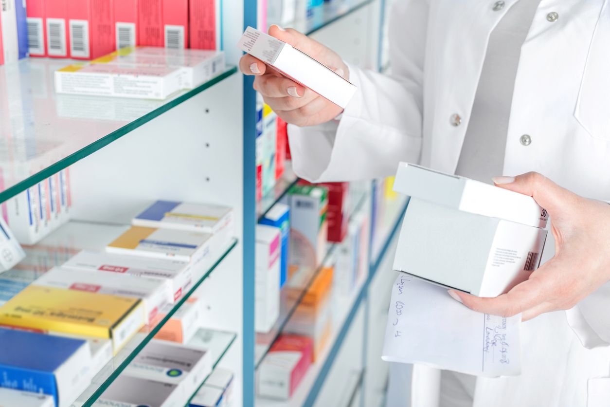 Pharmacist holding prescription and medicine