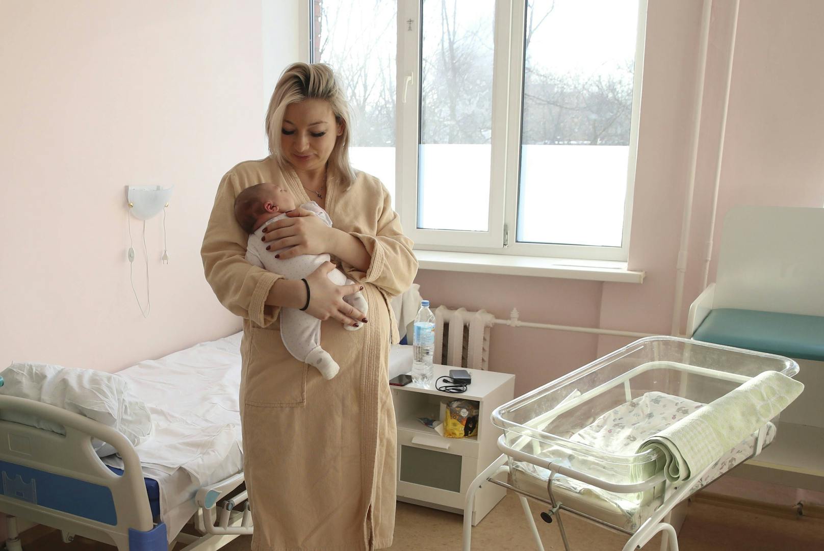 Eine junge russische Mutter hält ihr Neugeborenes in den Armen. Archivbild