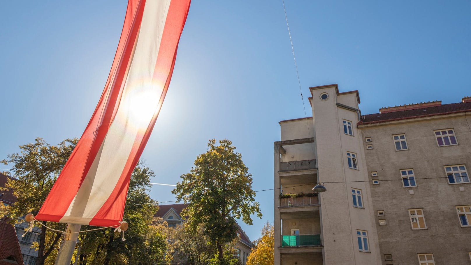 Die Sonne scheint durch eine Österreich-Fahne Ende Oktober. (Archivbild)