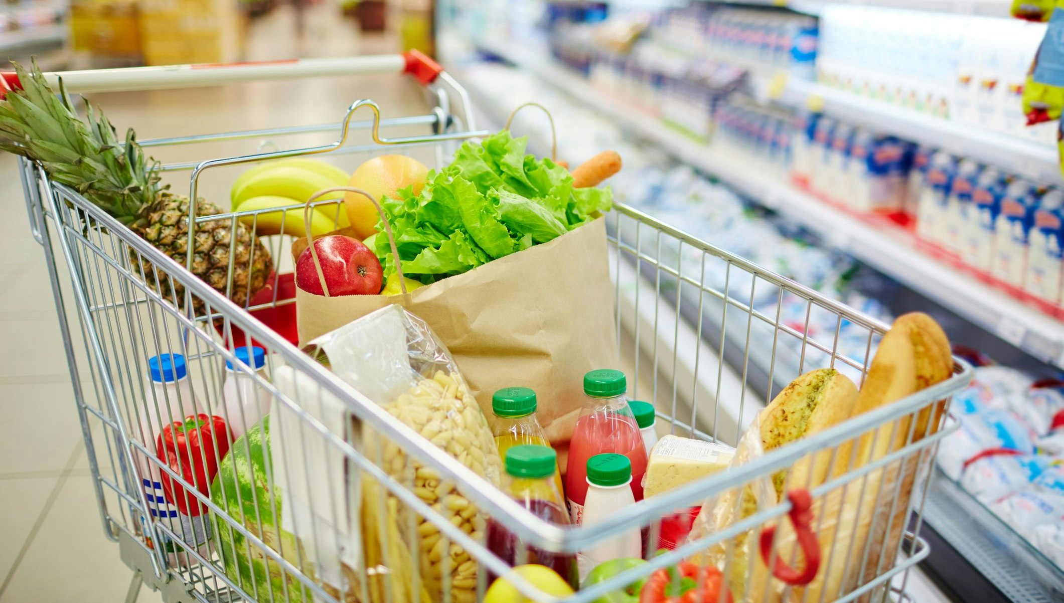 Different kinds of fresh food products in cart
