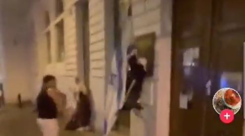 Das Video zeigt einen Vorfall, bei dem die Israel-Fahne bei einer Synagoge in Wien heruntergerissen wird.