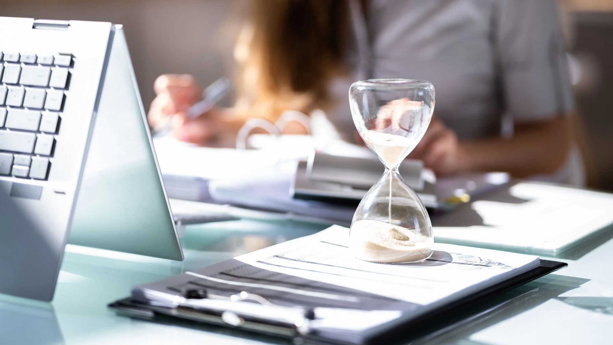 Hourglass And Time Crunch With Document In Office