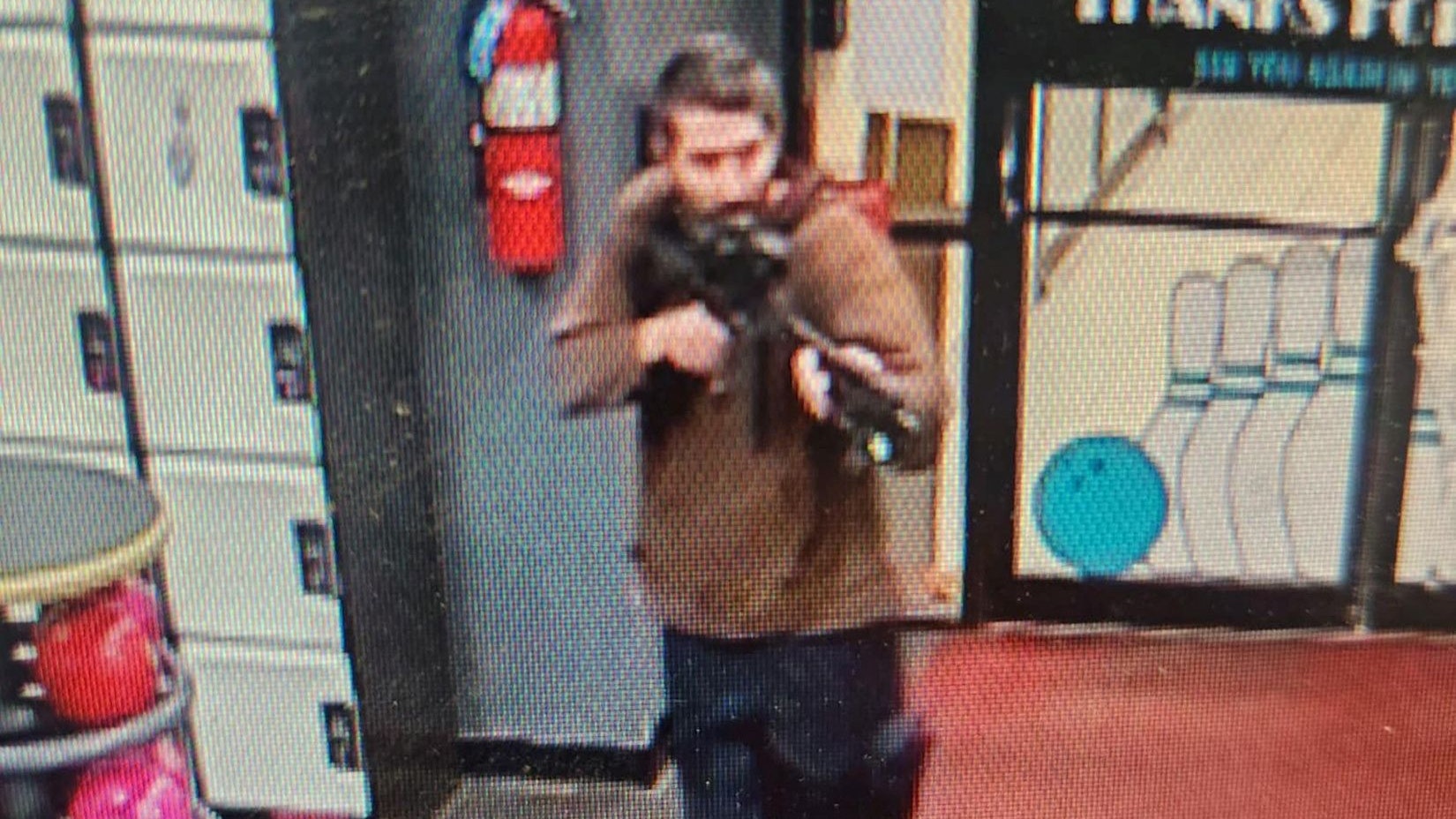 A still image from surveillance camera video shows a man with a gun, as the Androscoggin County Sheriff's Office appealed for information to identify a suspect in a mass shooting in Lewiston, Maine, U.S. October 25, 2025.  Androscoggin County Sheriff's Office/Handout via REUTERS.   THIS IMAGE HAS BEEN SUPPLIED BY A THIRD PARTY.