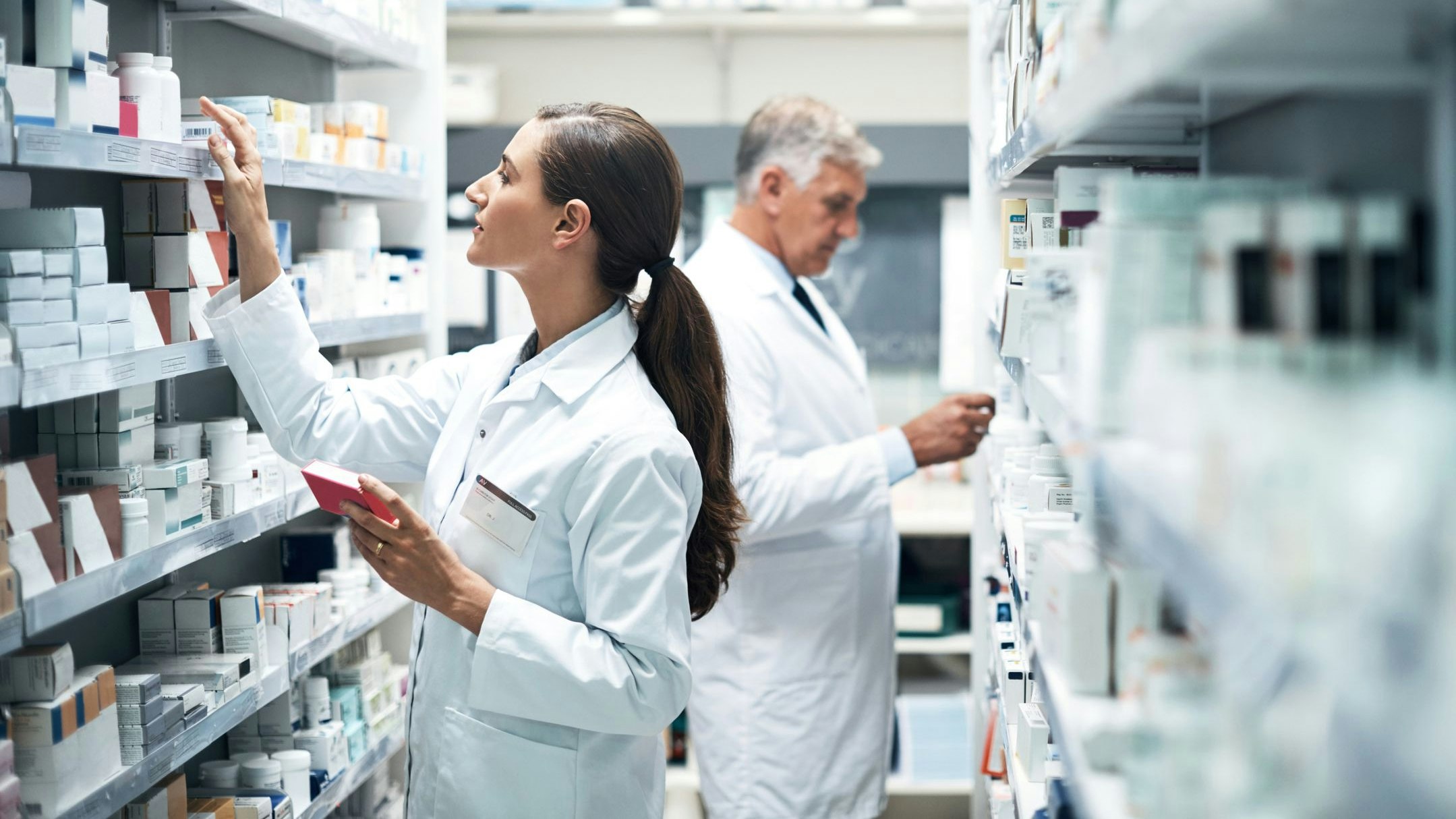 Cropped shot of two pharmacists checking products while working together in a dispensary