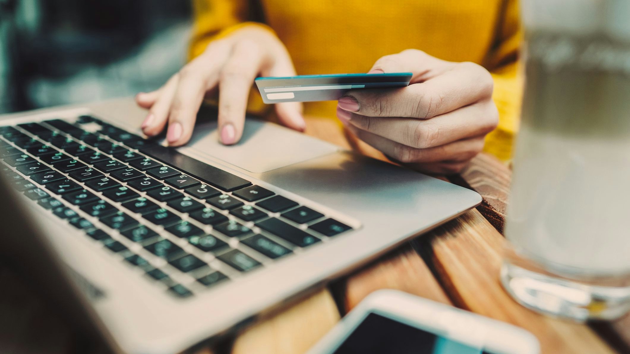 Woman's hands holding credit card and typing on keyboard on laptop