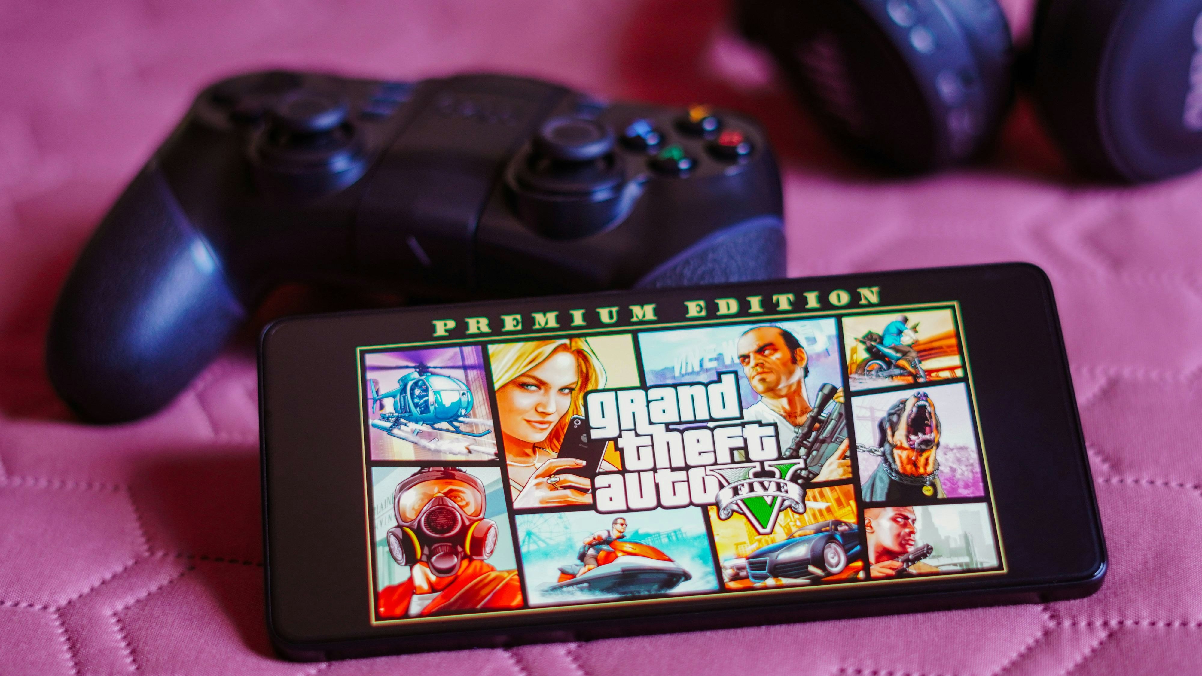 Photo illustration in Brazil - 9 Oct 2023 In this photo illustration, the Grand Theft Auto V GTA logo is displayed on a smartphone screen, next to a gamepad. Brazil NOxUSExINxGERMANY PUBLICATIONxINxALGxARGxAUTxBRNxBRAxCANxCHIxCHNxCOLxECUxEGYxGRExINDxIRIxIRQxISRxJORxKUWxLIBxLBAxMLTxMEXxMARxOMAxPERxQATxKSAxSUIxSYRxTUNxTURxUAExUKxVENxYEMxONLY Copyright: xSOPAxImagesx Editorial use only sipausa_48904704