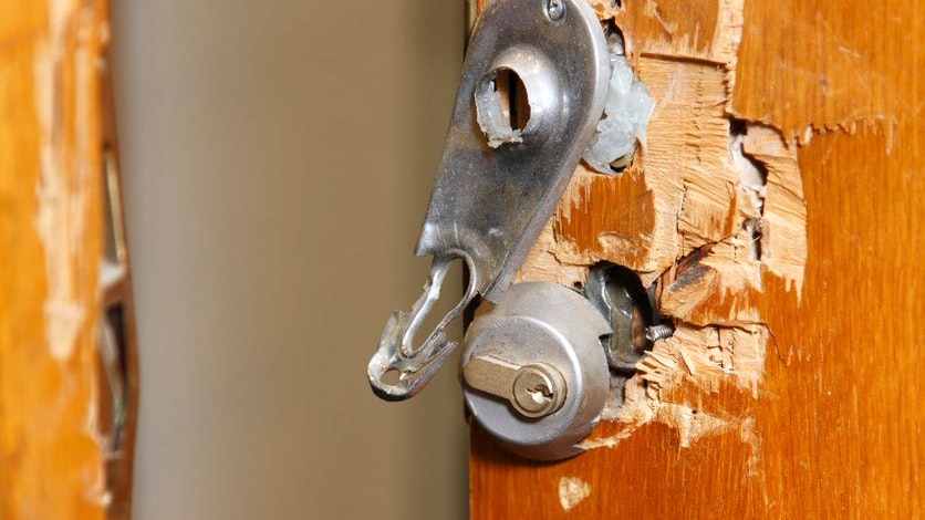 Broken lock and door frame damaged from break-in,open door