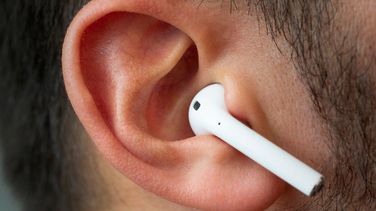 Izmir, Turkey - July  12, 2019: Close up shot of the one of Apple brand airpods on a caucasian white males ear.