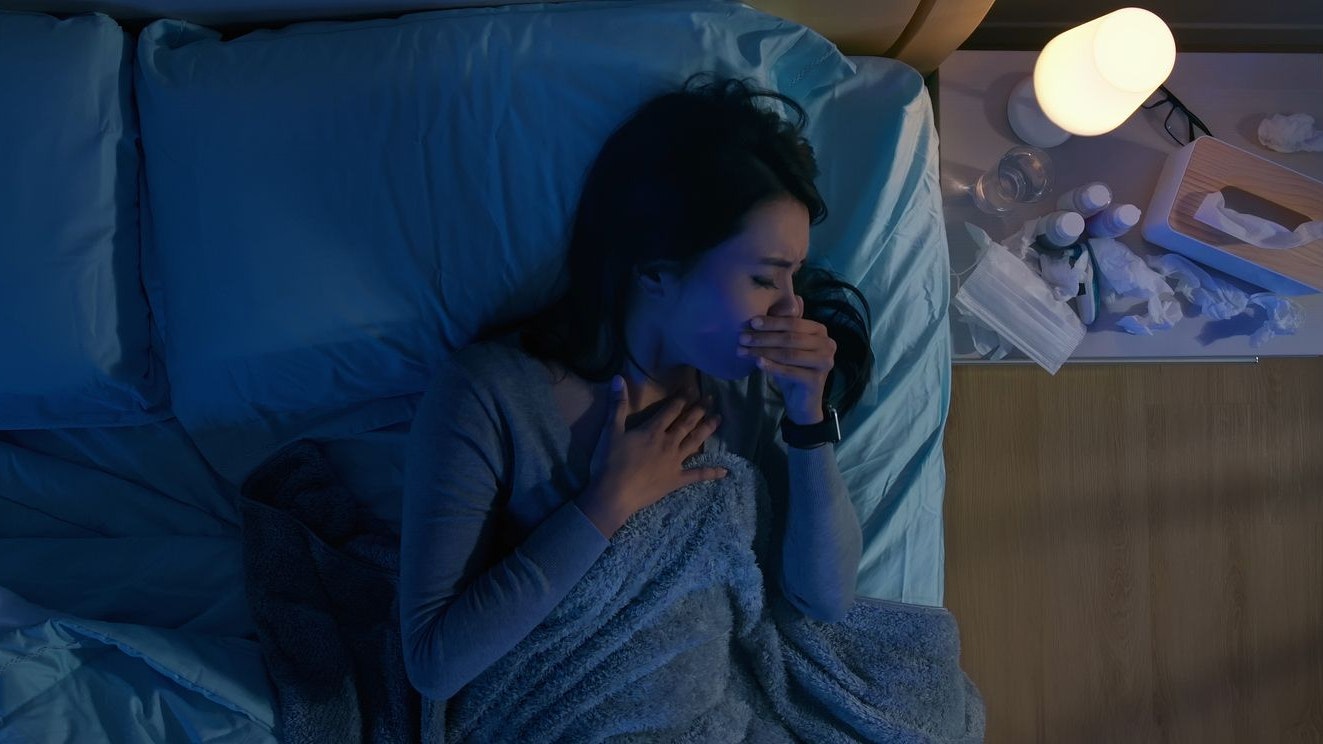 Top view of asian woman has illness from colds or flu and sore throat on bed at night