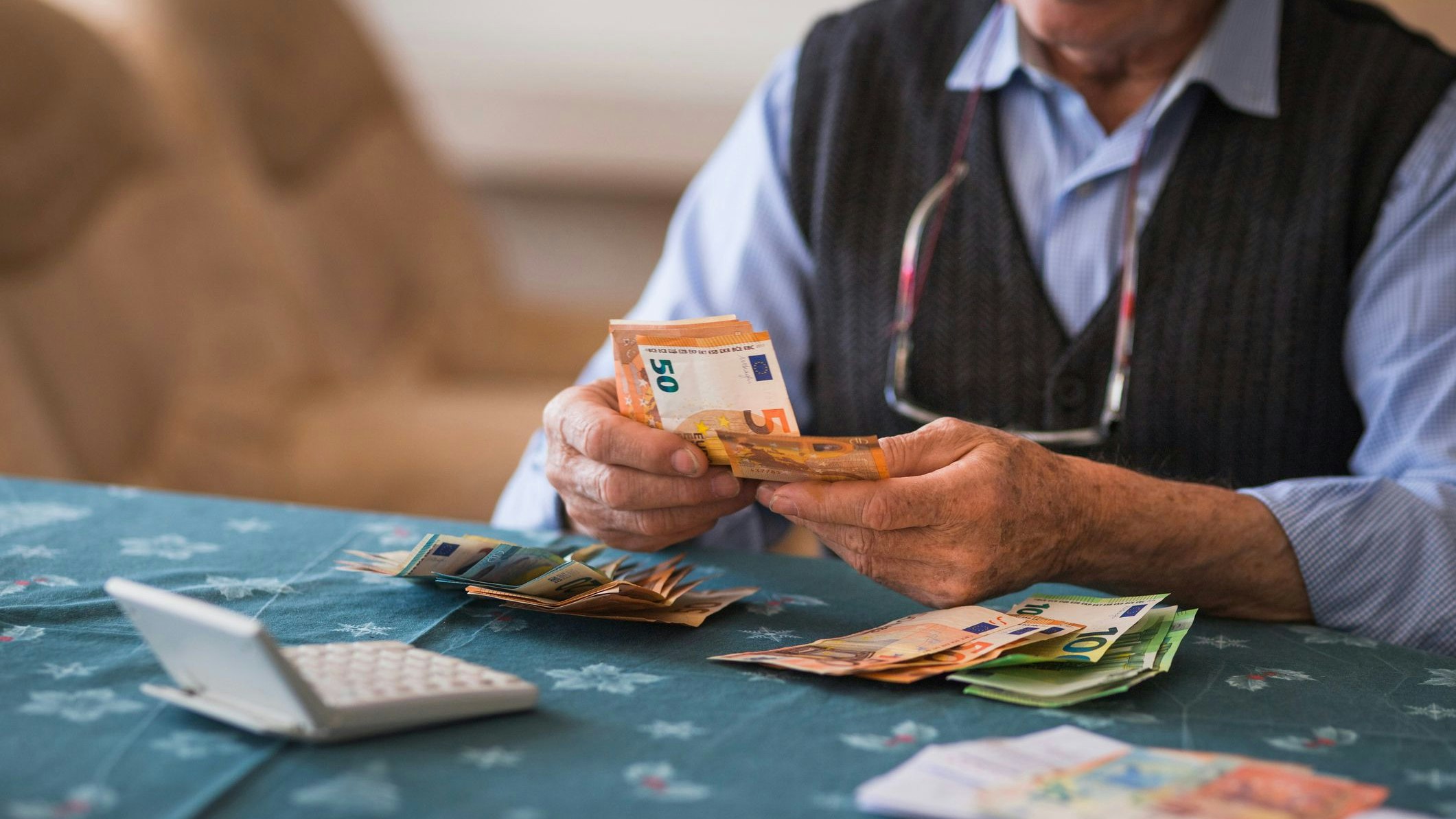 Close-up of a senior man counting money in European Union currency