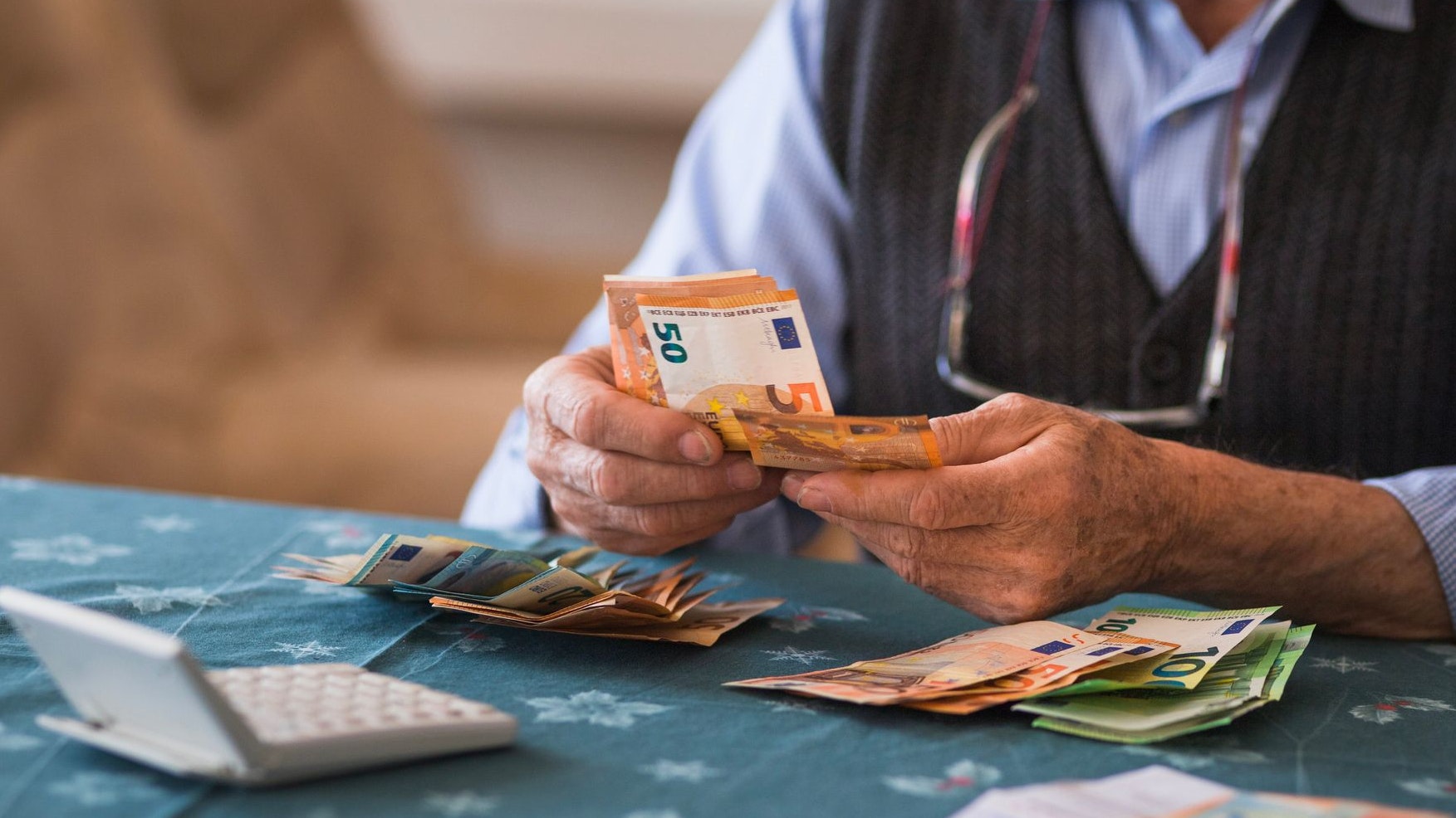 Close-up of a senior man counting money in European Union currency