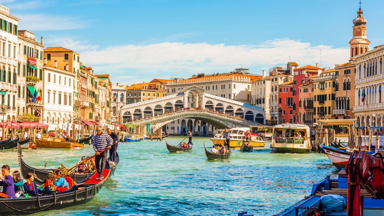Venice, Italy - September 23, 2019: Panoramic view of the Grand Canal with gondolas and the Rialto Bridge (Ponte di Rialto). Venice, Italy.