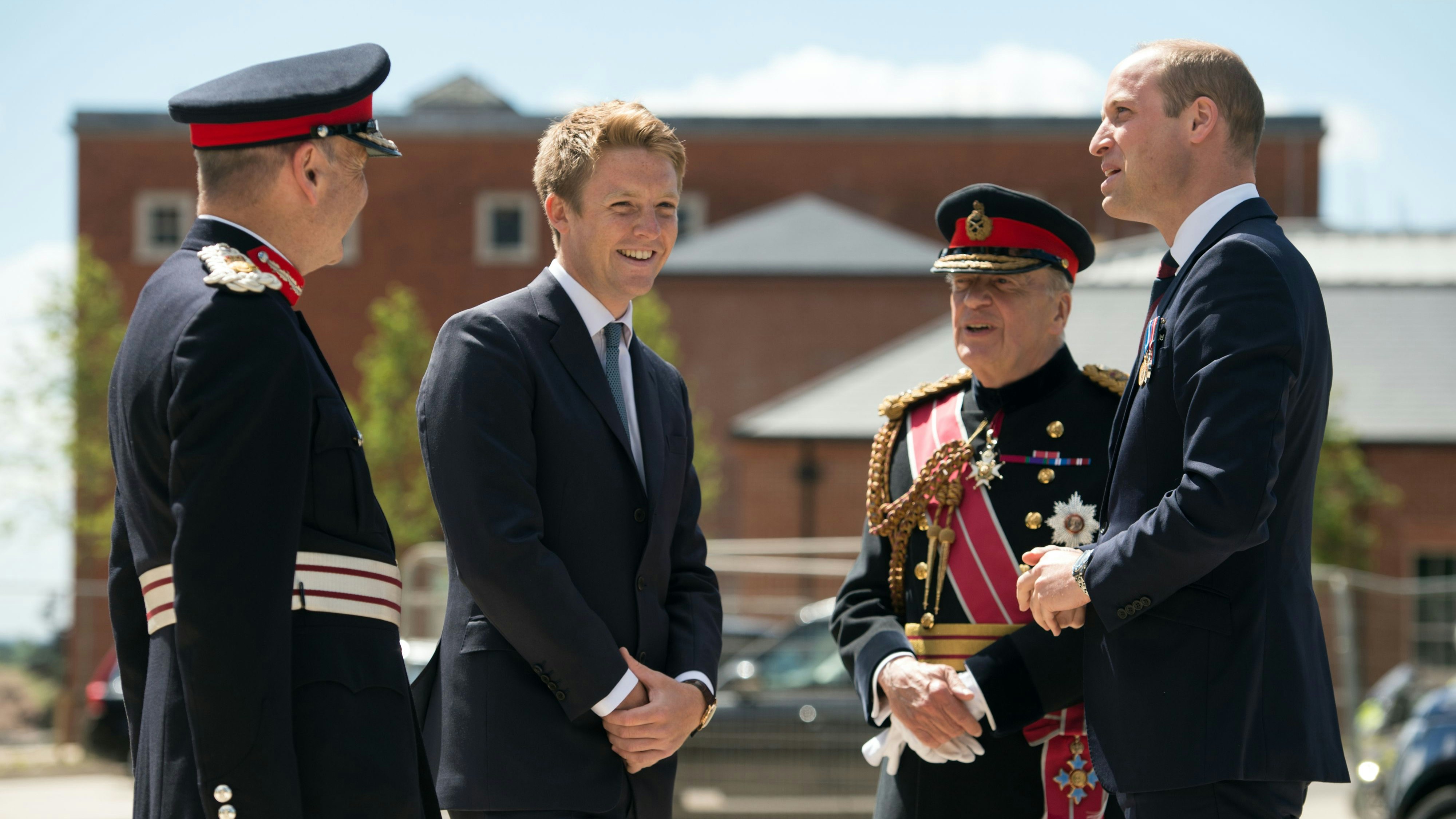 Britain's Prince William, Duke of Cambridge (R) is greeted by General Timothy Granville-Chapman (2R), Hugh Grosvenor, the Duke of Westminster (2L) and John Peace (L) as he arrives to attend the official handover of the newly built Defence and National Rehabilitation Centre (DNRC), which will provide world-class rehabilitation facilities for members of the Armed Forces, on the Stanford Hall Estate in Nottinghamshire.
