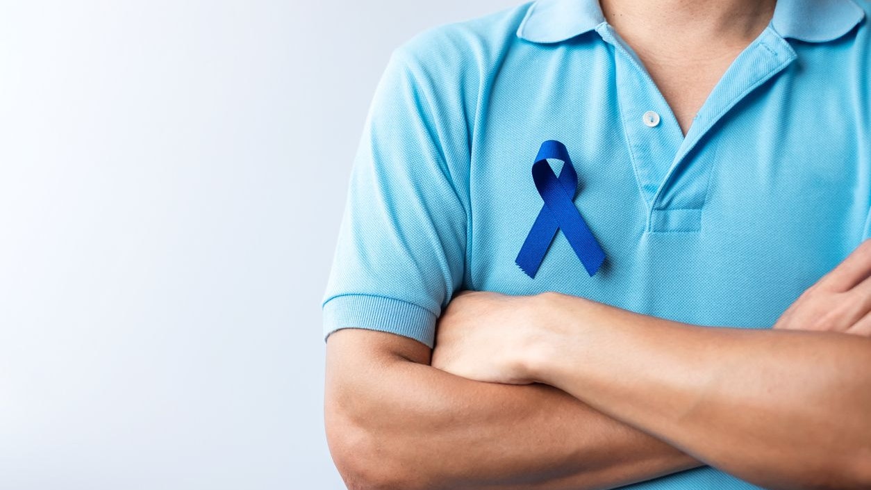 March Colorectal Cancer Awareness month, Woman holding dark Blue Ribbon for supporting people living and illness. Healthcare, hope and World cancer day concept