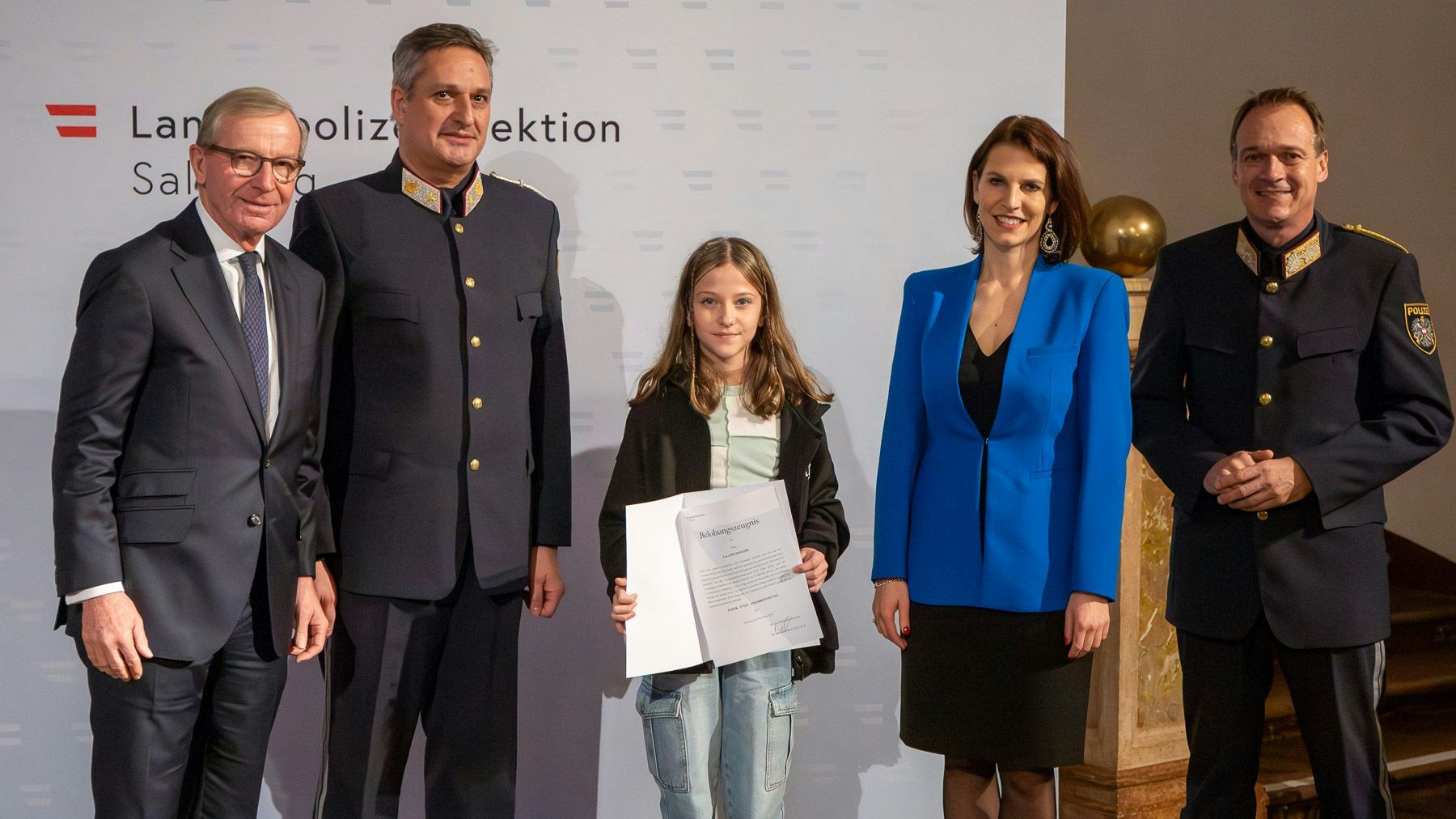 Landeshauptmann Wilfried Haslauer, Christoph Gummerer, Polizei Salzburg, Europa- und Verfassungsministerin Karoline Edtstadler und Landespolizeidirektor Bernhard Rausch mit Lara H. (Mitte), die durch ihre schnelle Reaktion und ihr beherztes Handeln einer Verletzten Person half.