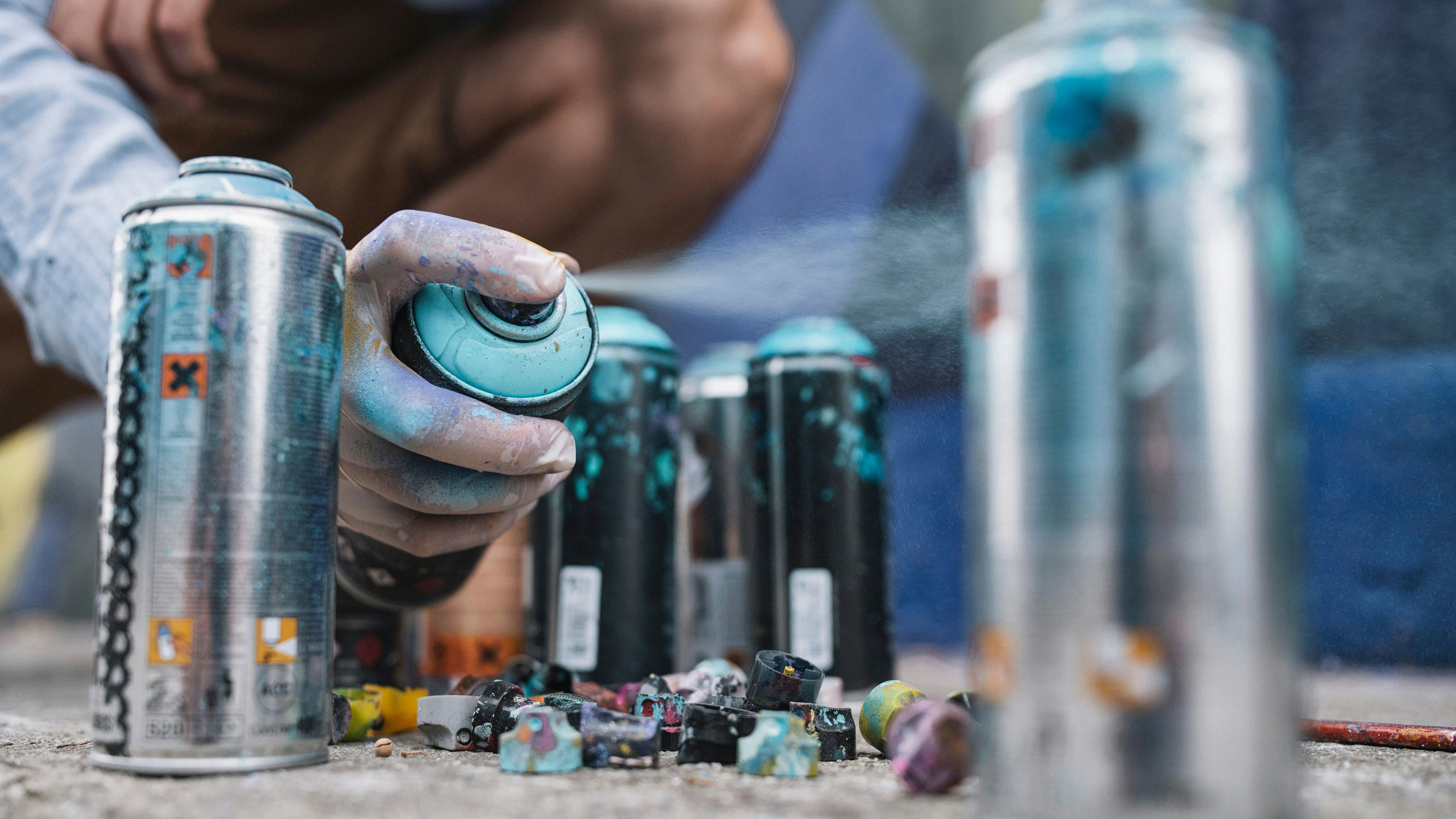 Graffiti Artist's Hand Reaching For Spray Bottle