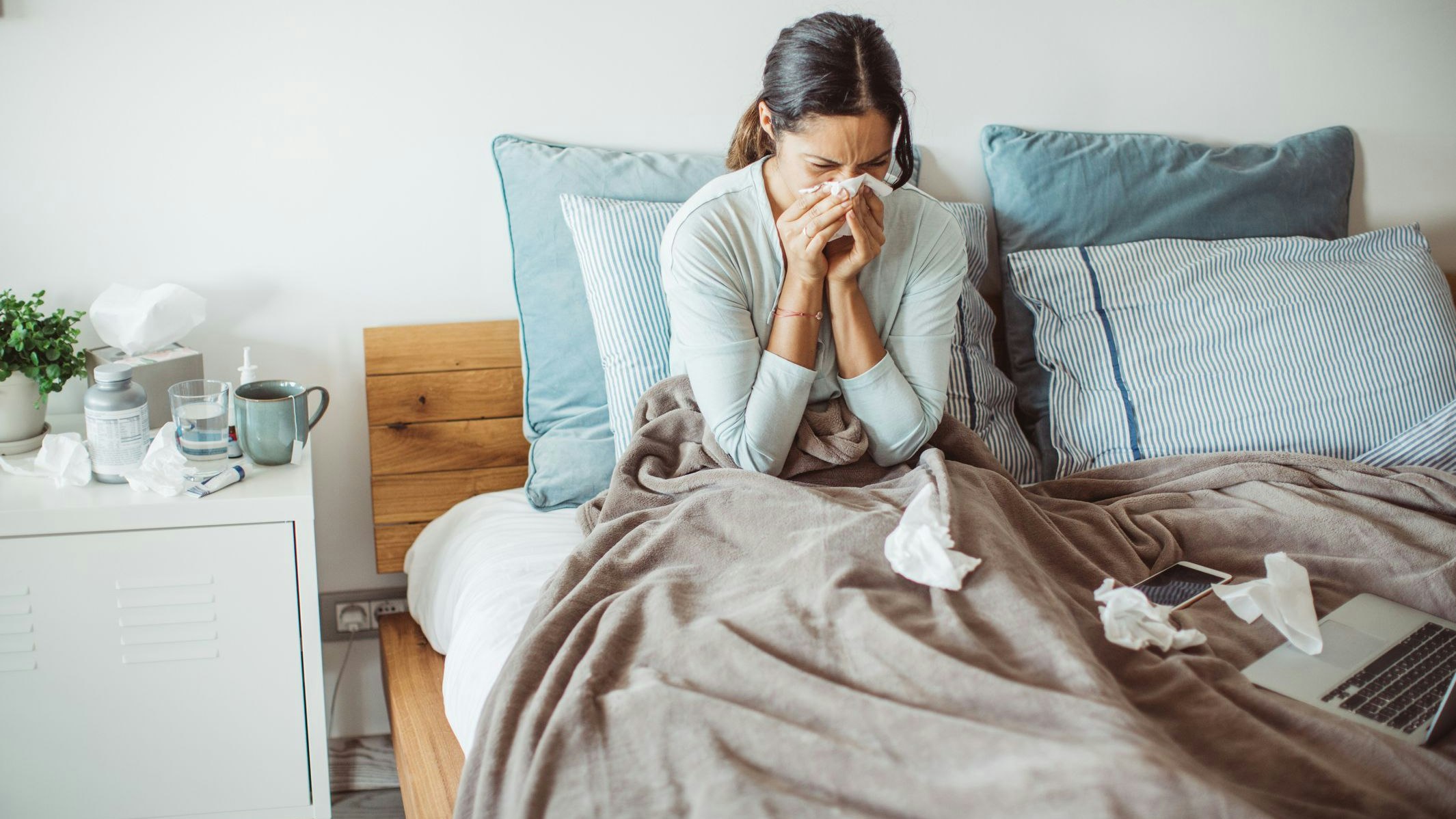 Woman with flu in bed, she use home medicine to handle sickness
