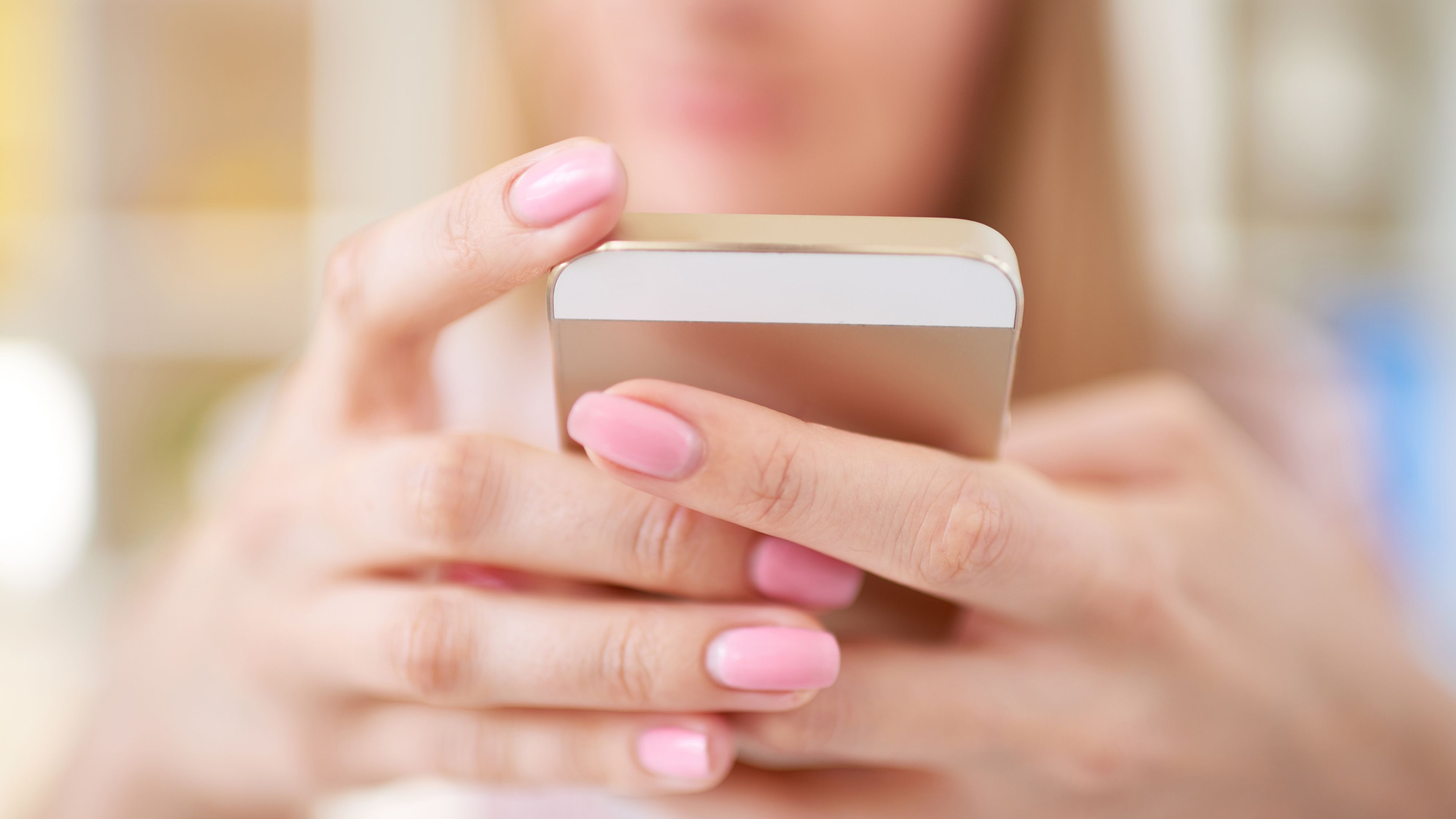 Close up of female hands holding a phone