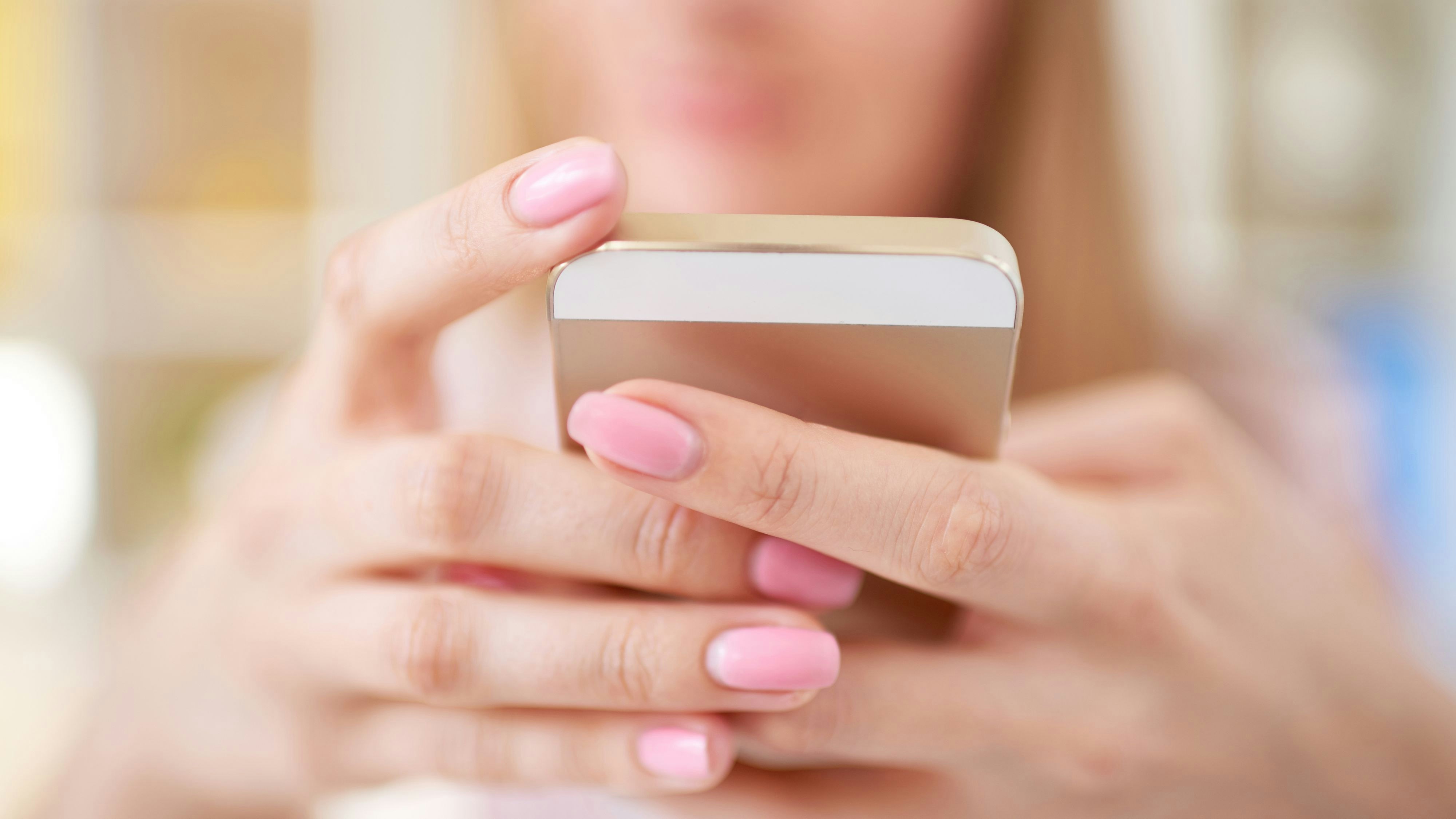 Close up of female hands holding a phone