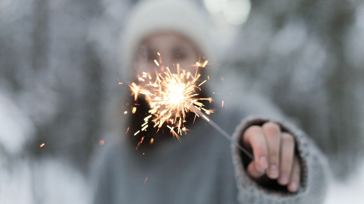 the girl holds sparklers in her hand