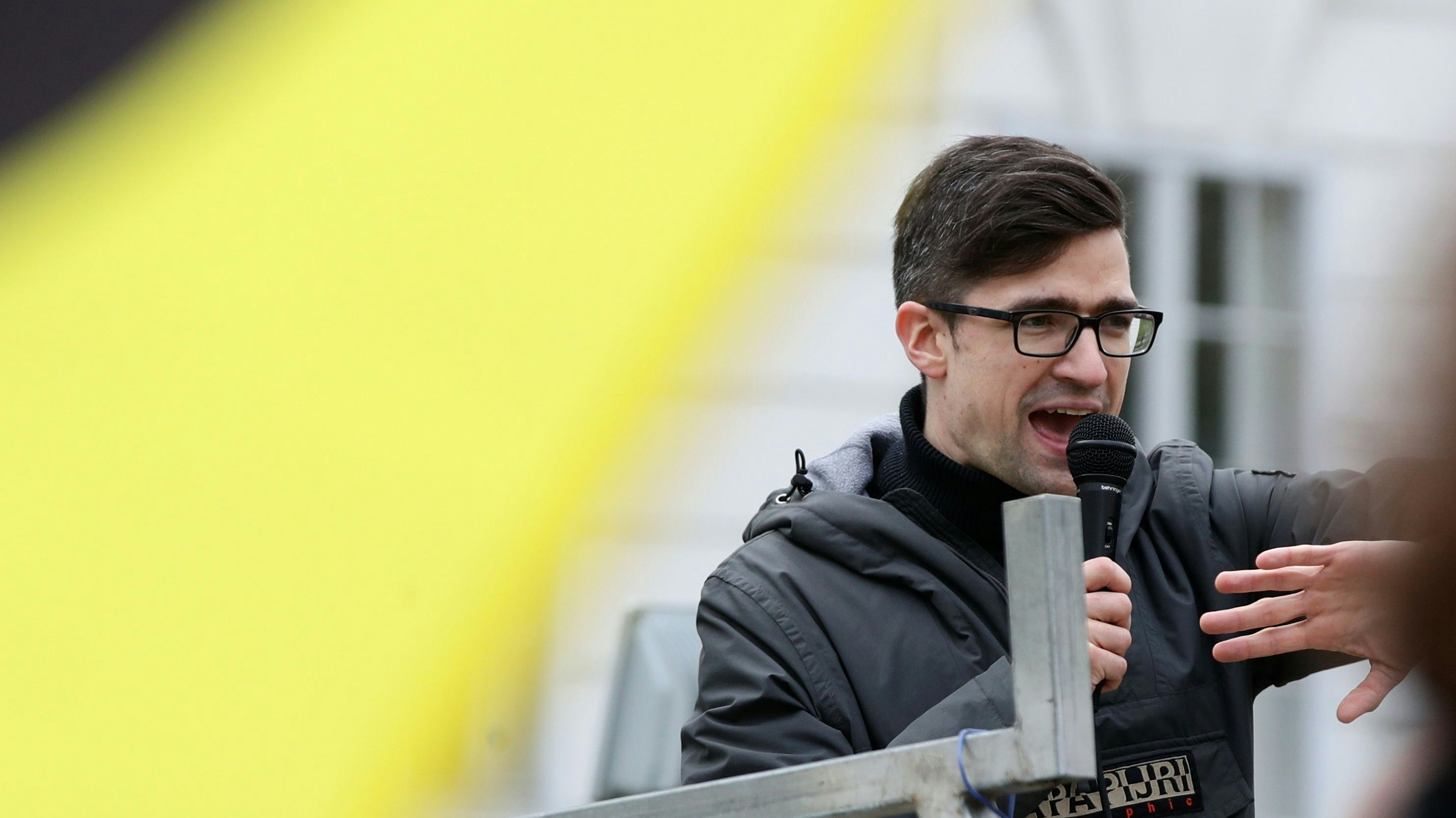 Leader of Austria's Identitarian Movement Martin Sellner speaks during a protest against a police raid at his house, outside the Justice Ministry in Vienna, Austria, April 13, 2019. REUTERS/Lisi Niesner