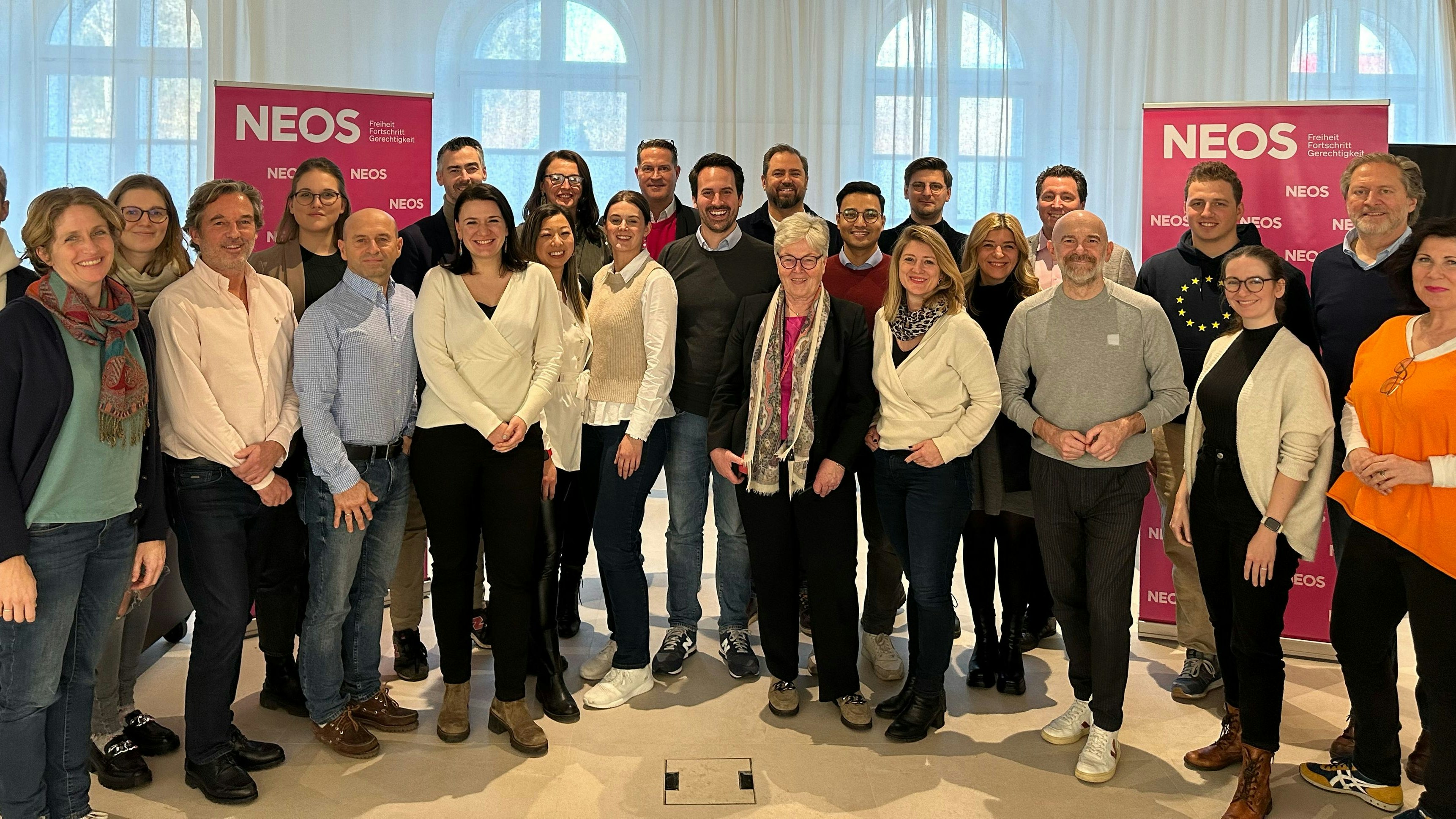 Neos Wien Landessprecher Christoph Wiederkehr (Mitte) mit den 23 frisch gewählten Bezirkssprechern.