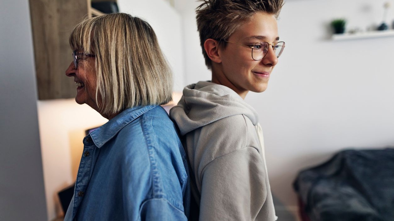 Teenage grandson has outgrown his grandmother. They are standing next to each other to compare height. Canon R5