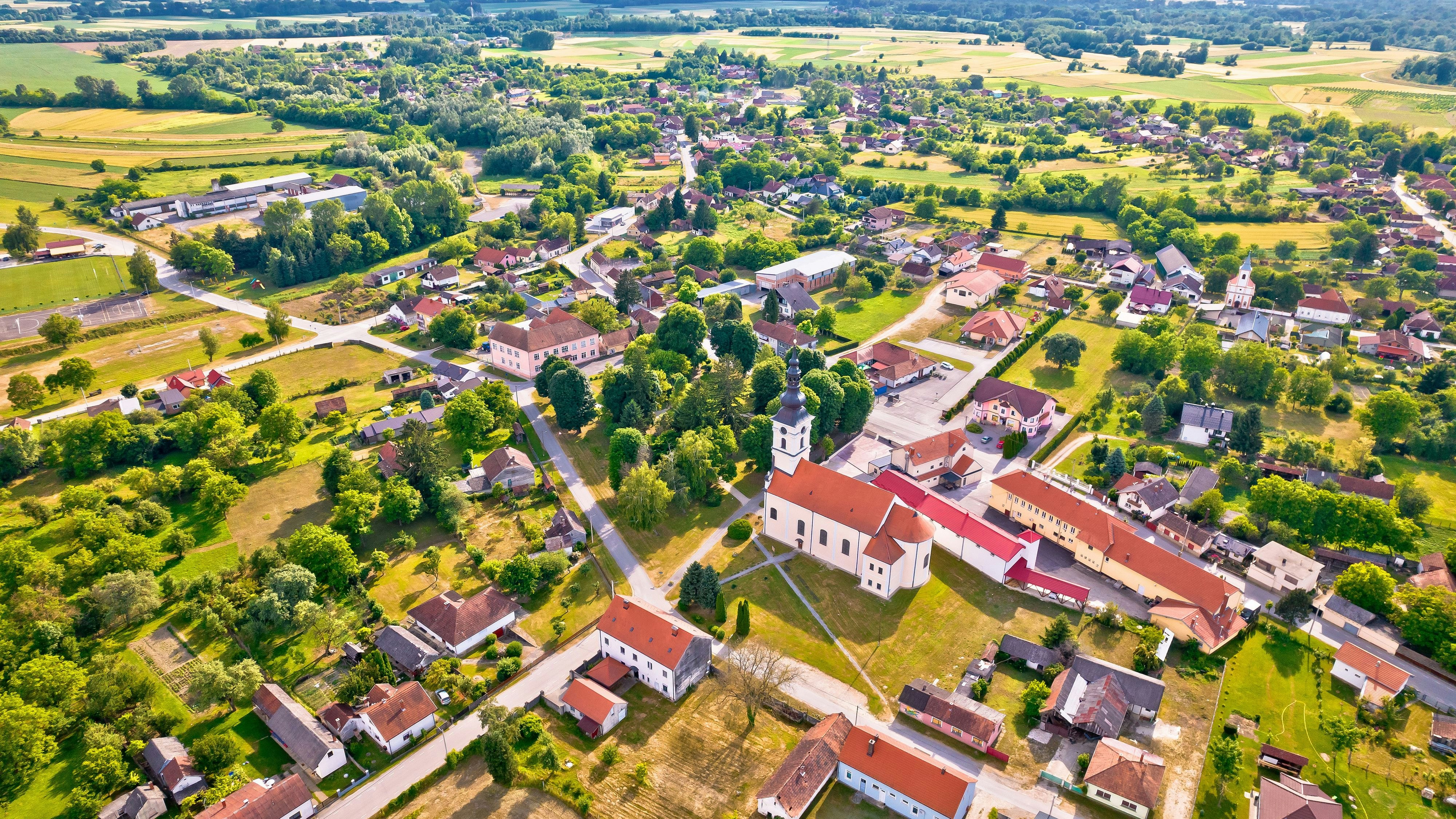 Village of Legrad church and green landscape aerial view