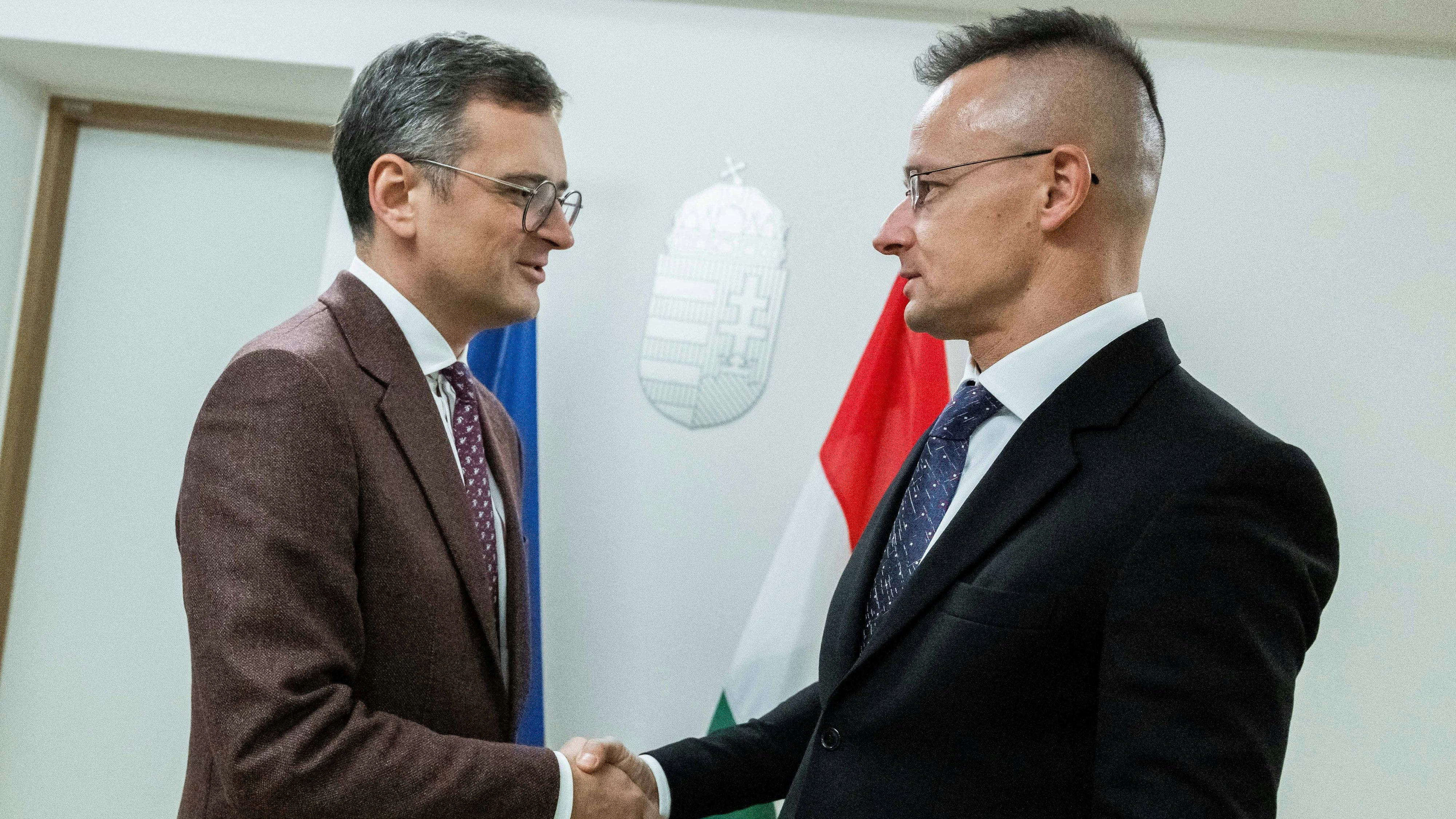 Ukrainian Foreign Minister Dmytro Kuleba Hungarian Minister of Foreign Affairs and Trade Peter Szijjarto shake hands before their meeting on sides of a European Union Foreign Ministers council, in Brussels, Belgium, December 11, 2023. Ministry of Foreign Affairs and Trade of Hungary/KKM Sajto/Handout via REUTERS THIS IMAGE HAS BEEN SUPPLIED BY A THIRD PARTY.