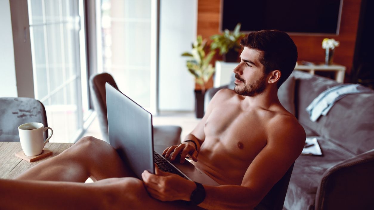 Modern Male Using Laptop While Relaxing With Cup Of Coffee