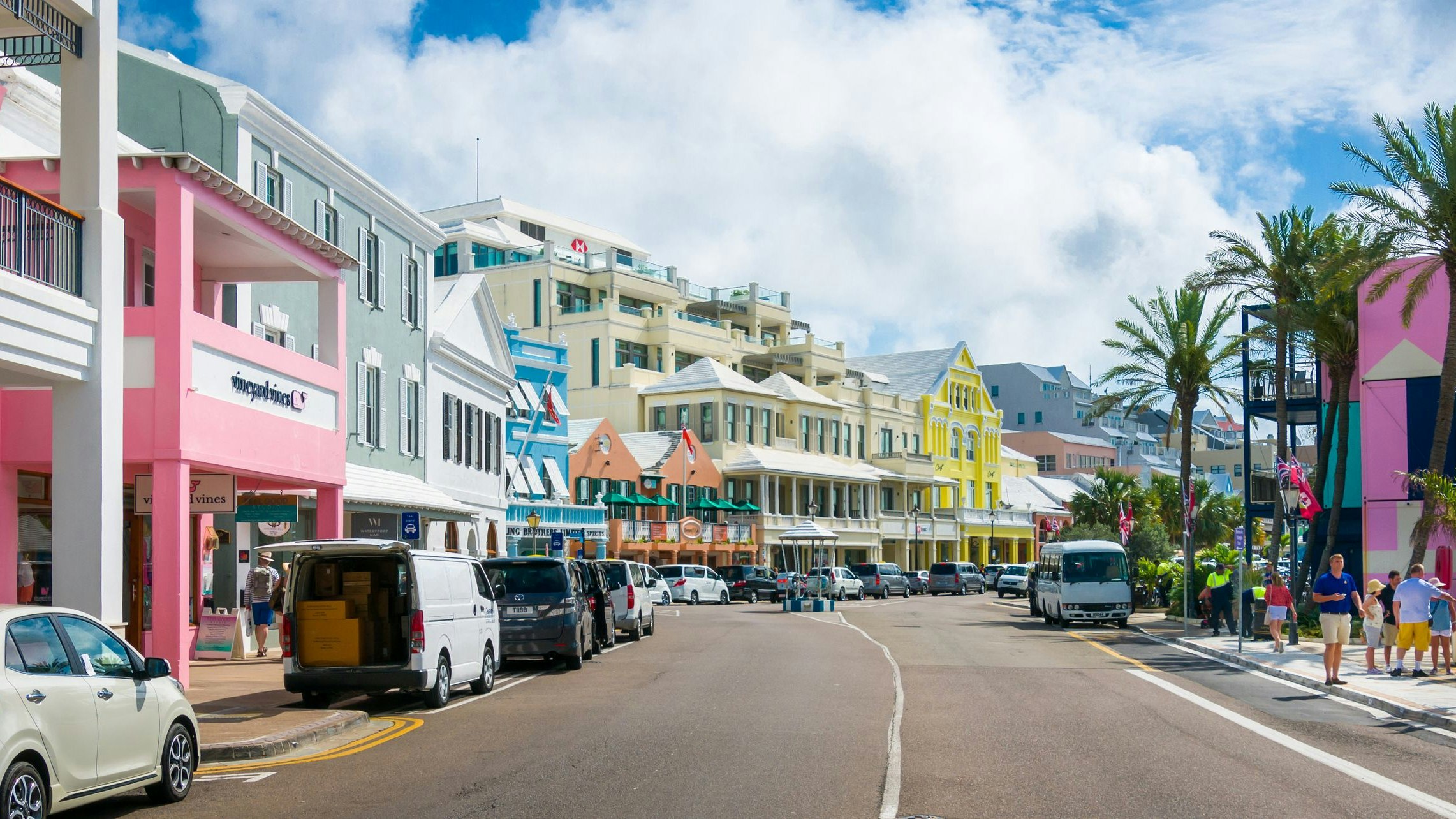 Hamilton, Bermuda May 24, 2022-  Visitors and locals walk past colorful and interesting shops, restaurants and stores along Front Street in Hamilton, Bermuda.  Offering a wide array of duty free merchandise, this street is a shopper's paradise.