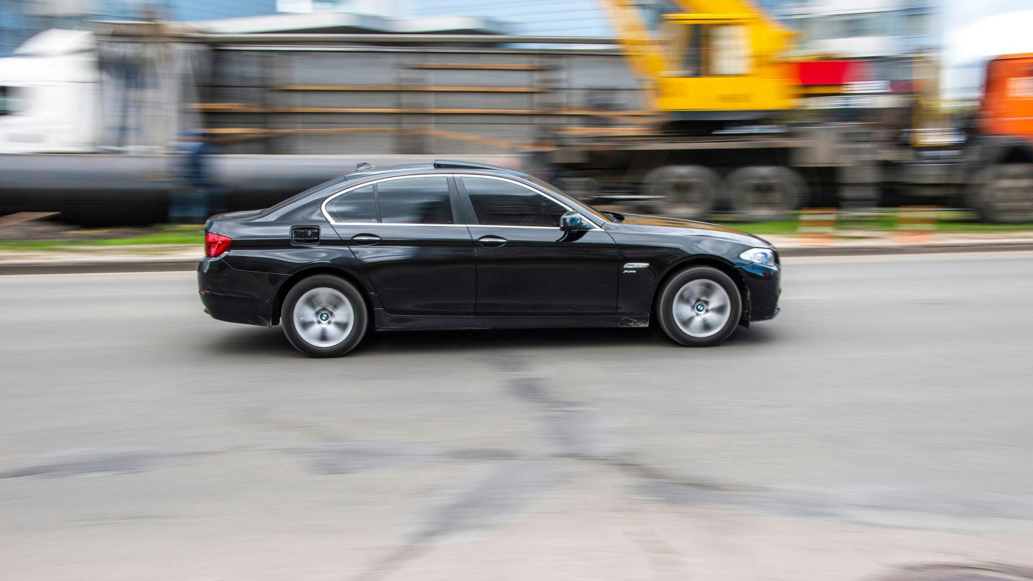 Ukraine, Kyiv - 26 April 2021: Black BMW 5 Series car moving on the street. Editorial