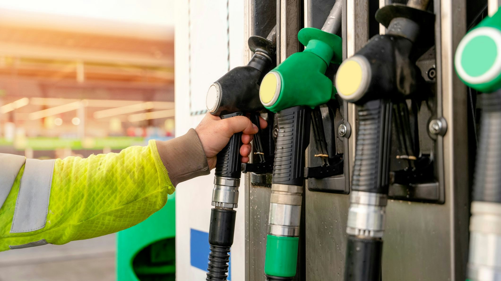 Colorful petrol and diesel nozzles of the dispenser machine at the gas fuel station