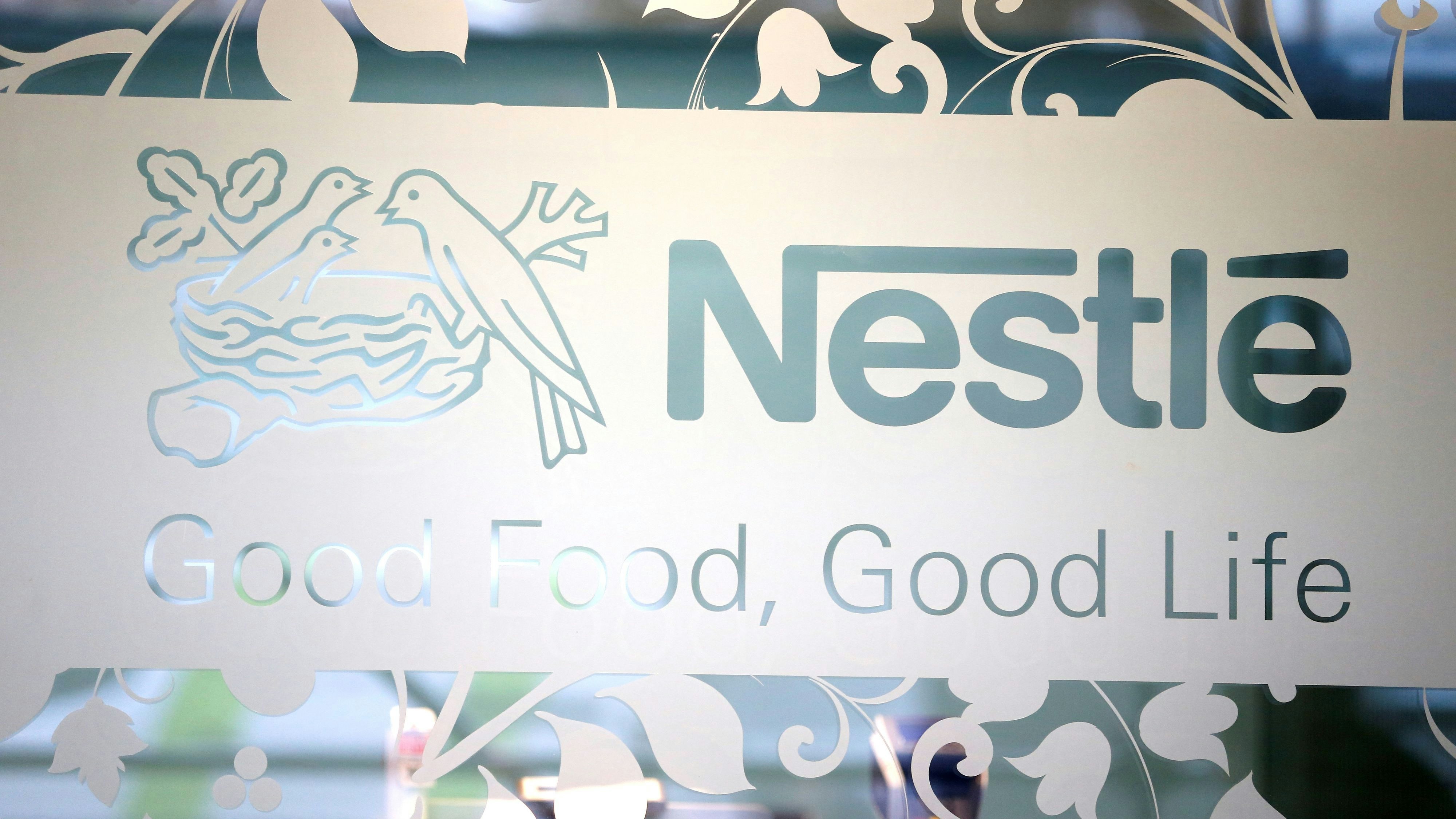 Nestle logo is pictured on the door of the supermarket of Nestle headquarters in Vevey, Switzerland, February 13, 2020. REUTERS/Pierre Albouy