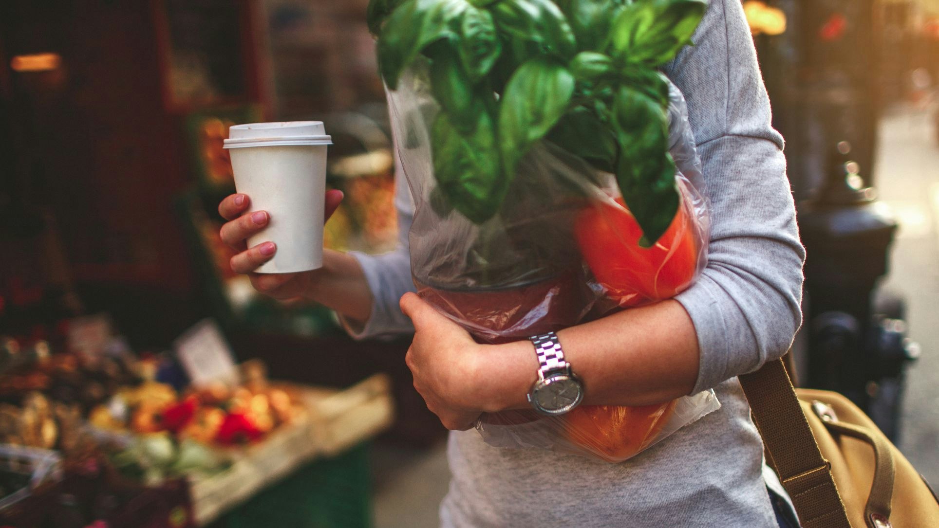 Portrait of a young woman having a cup of coffee to go, after a grocery shopping